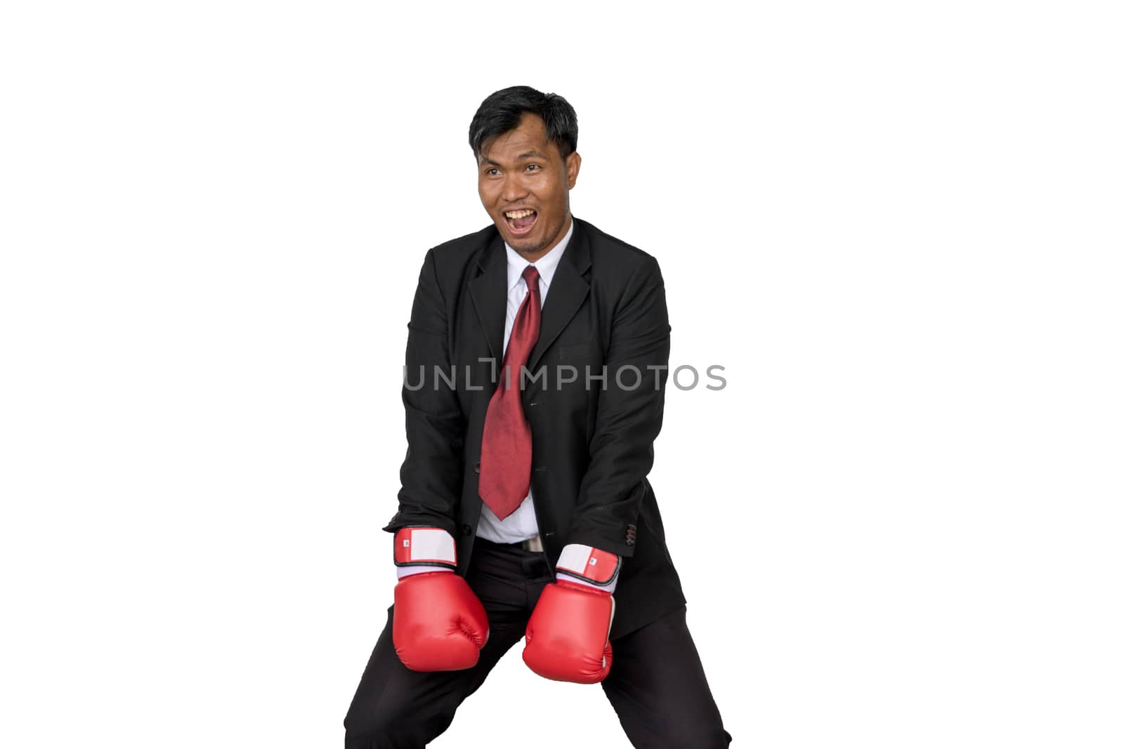 Asian businessman wearing boxing gloves to punch by minamija