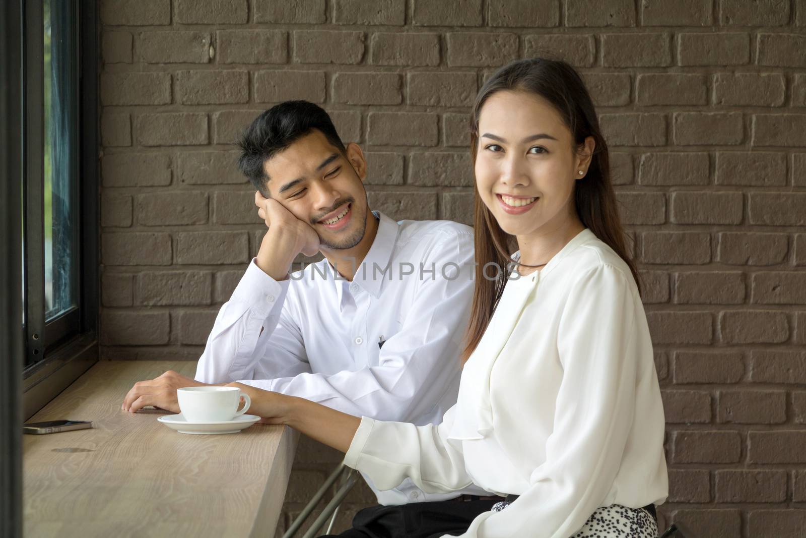 Asian young couple in love at a coffee shop by minamija