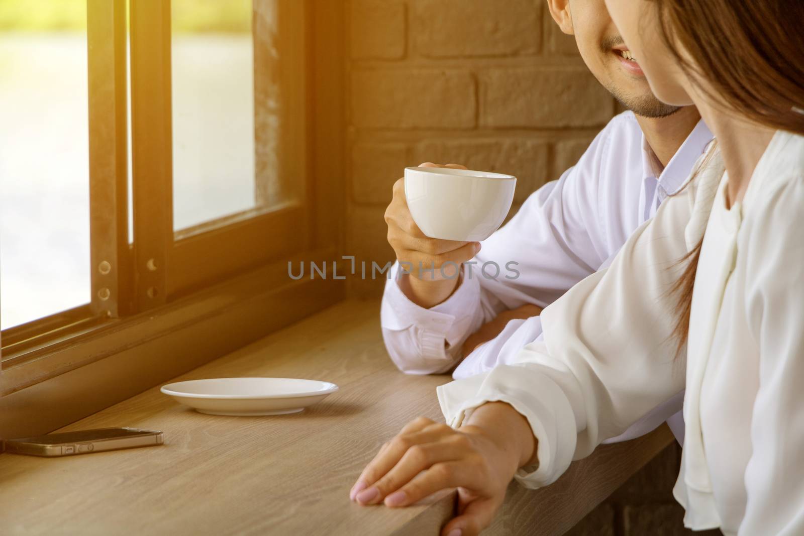 Asian young couple in love at a coffee shop, they are smile. Conception in coffee shop.