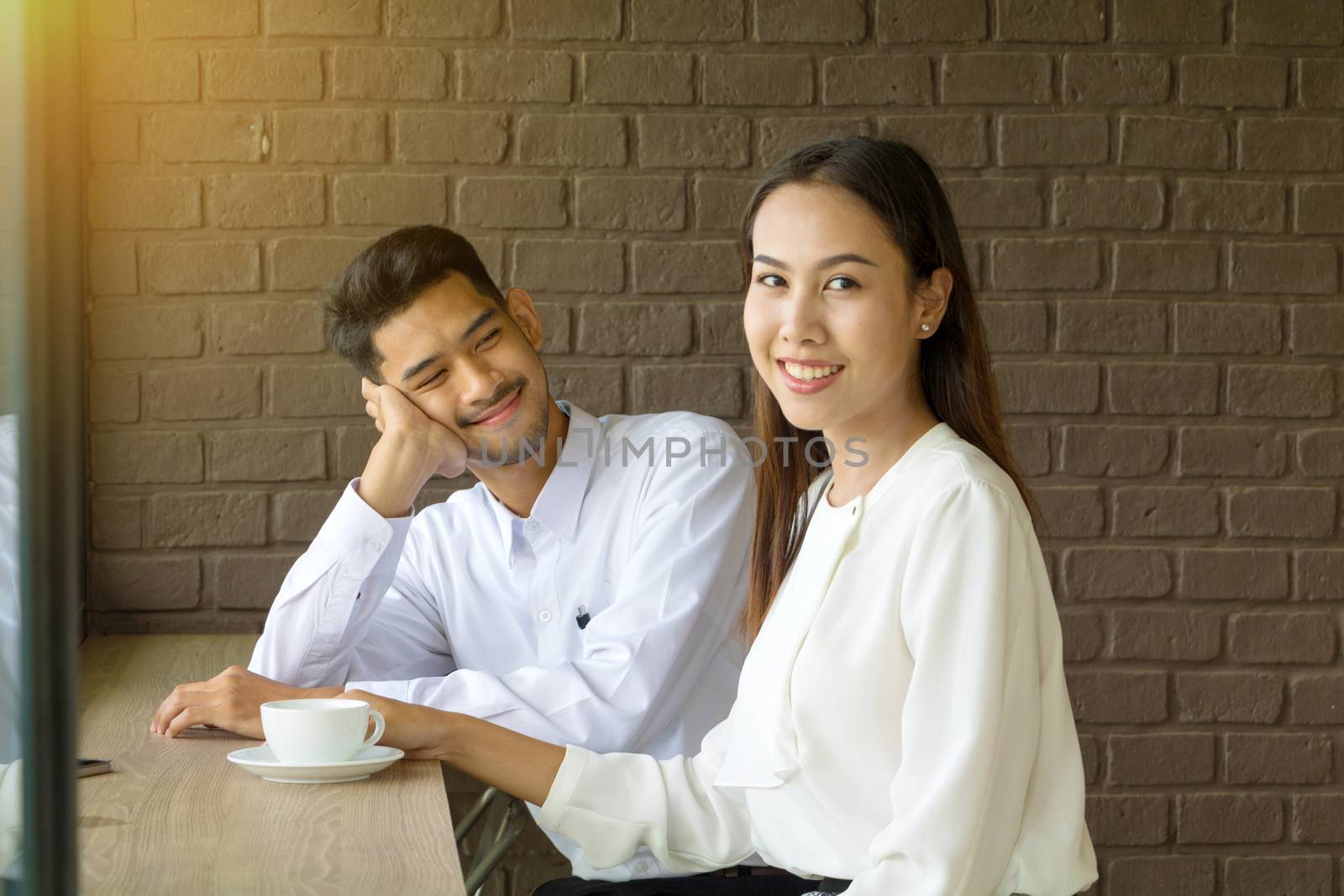 Asian young couple in love at a coffee shop by minamija