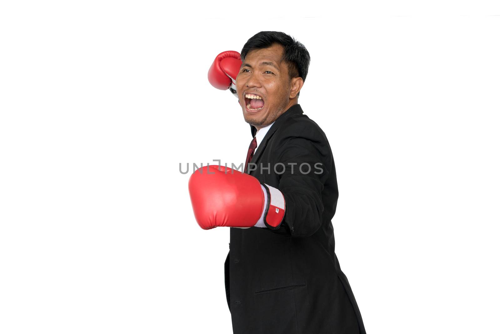 Young businessman wearing boxing gloves It shows that it is ready to fight the competition and problems in the future. Business Boxing concept.