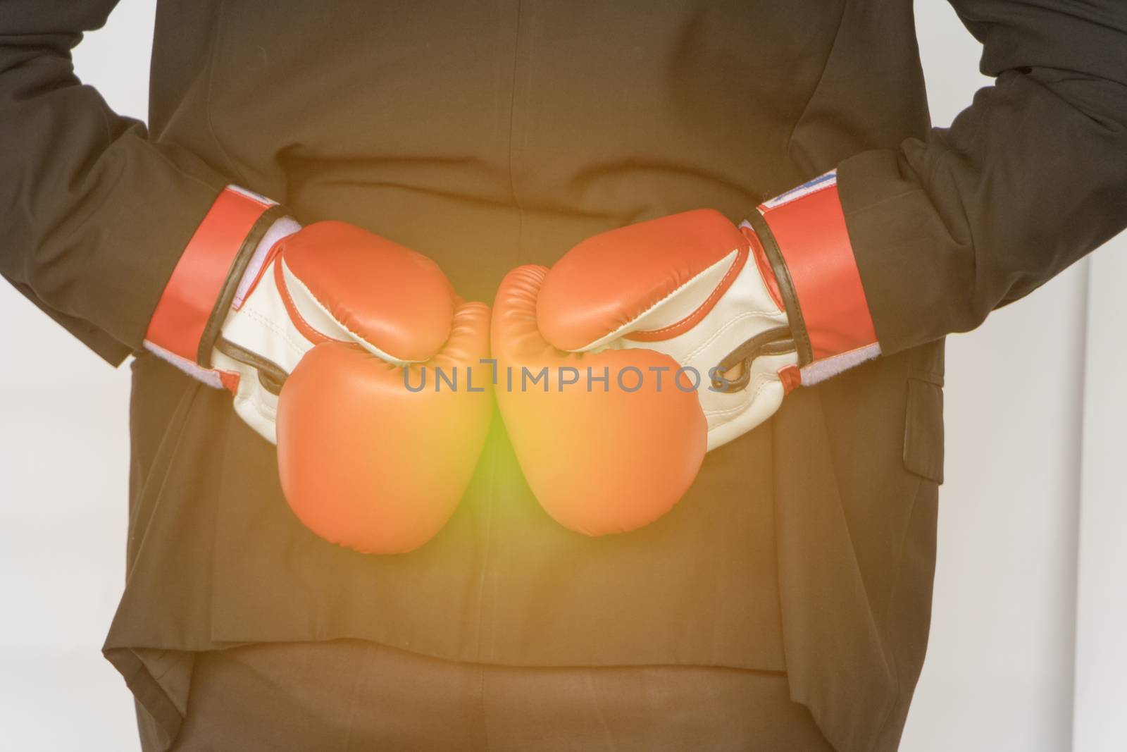 Young businessman wearing boxing gloves It shows that it is ready to fight the competition and problems in the future. Business Boxing concept.