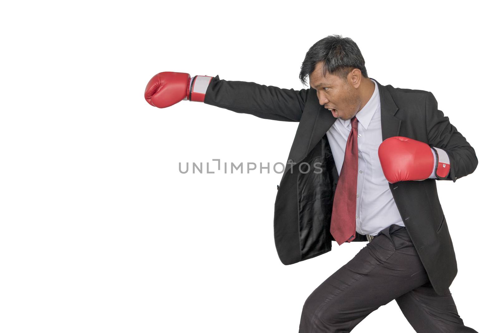 Asian businessman Put boxing gloves to punch. by minamija
