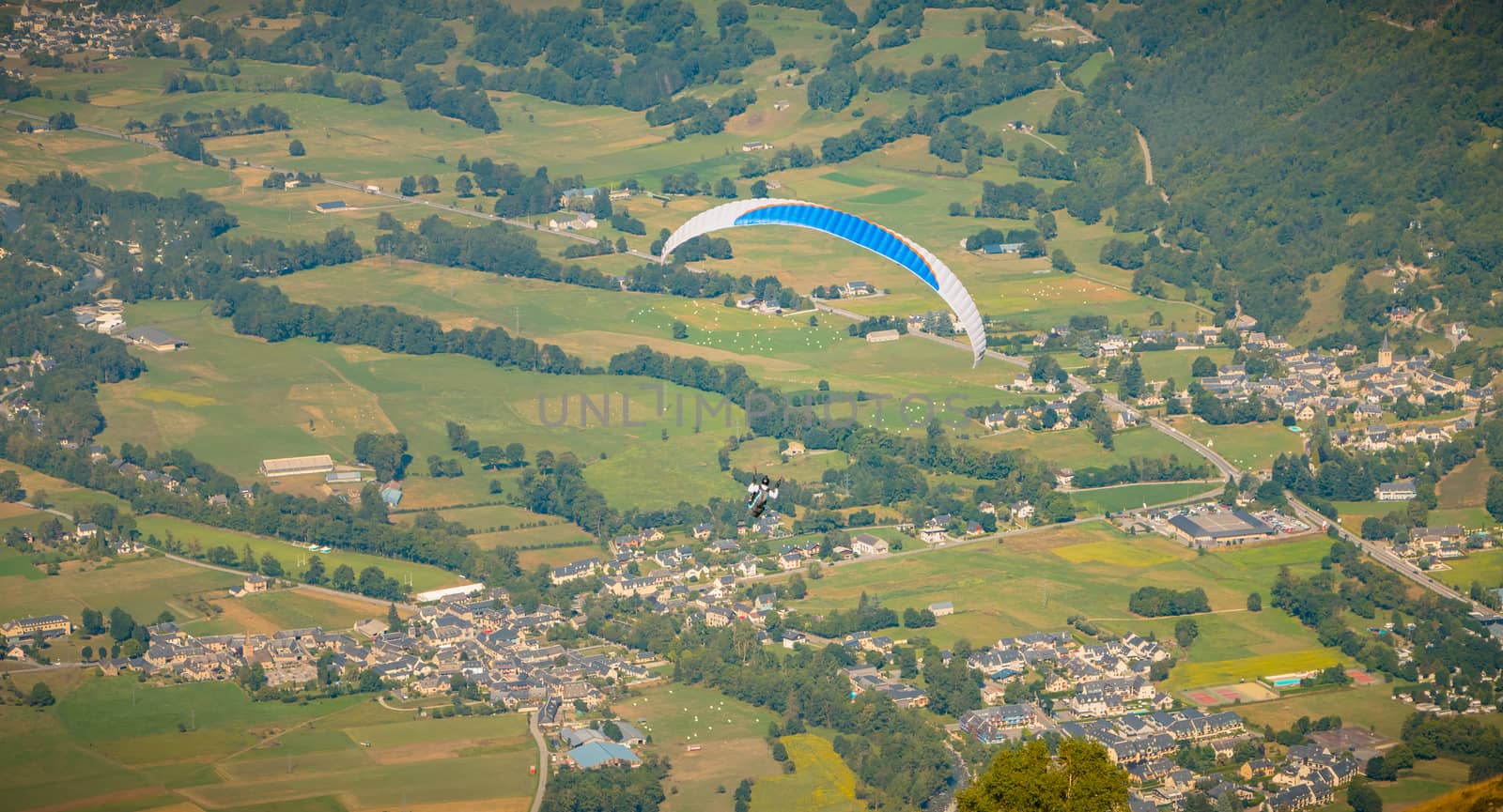 Saint Lary Soulan, France - August 20, 2018: paragliding in flight at the top of the mountain at 1700 meters above sea level flying over the valley on a summer day