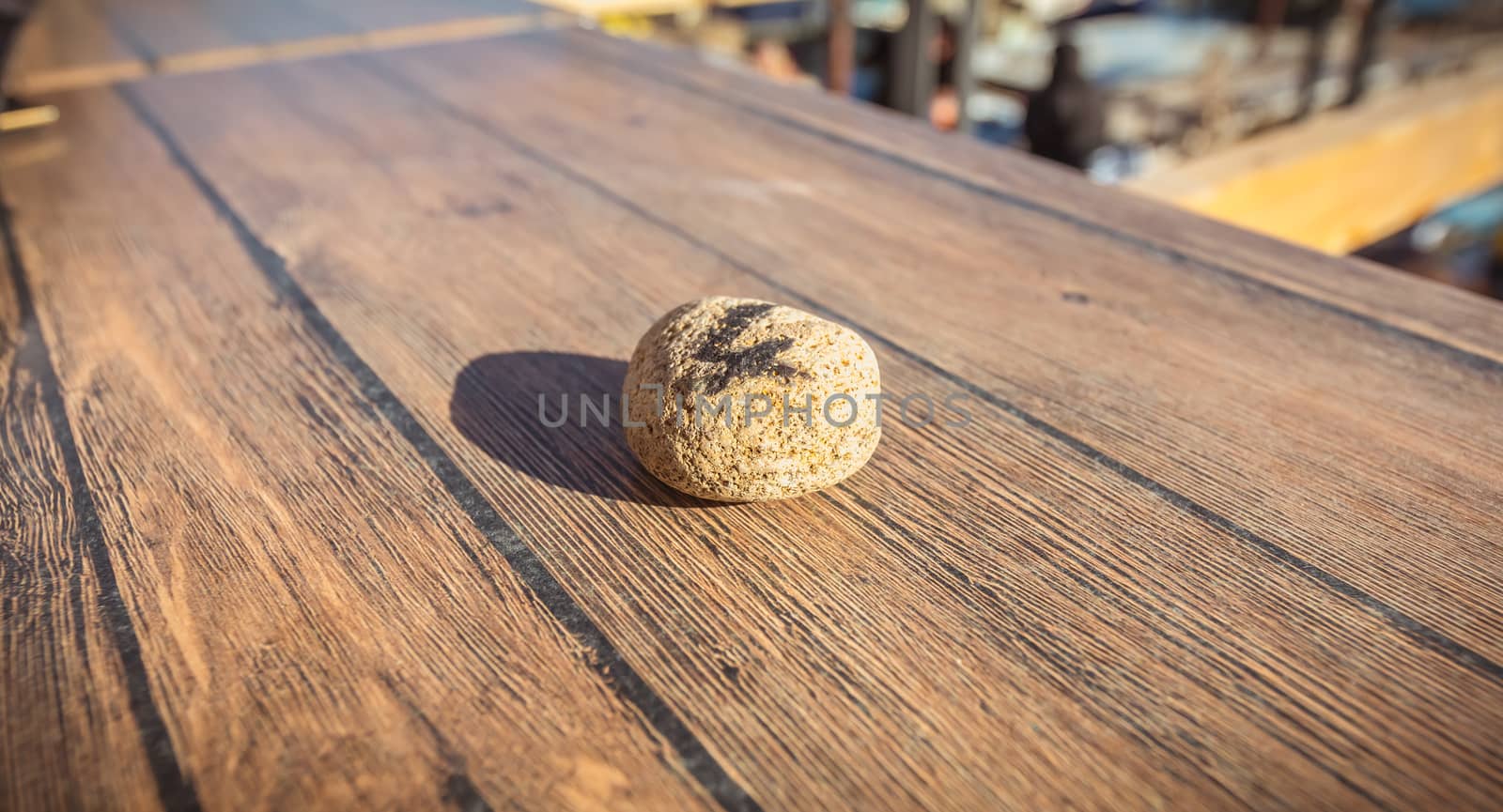 figure 4 written in felt on a small stone on the table of a restaurant