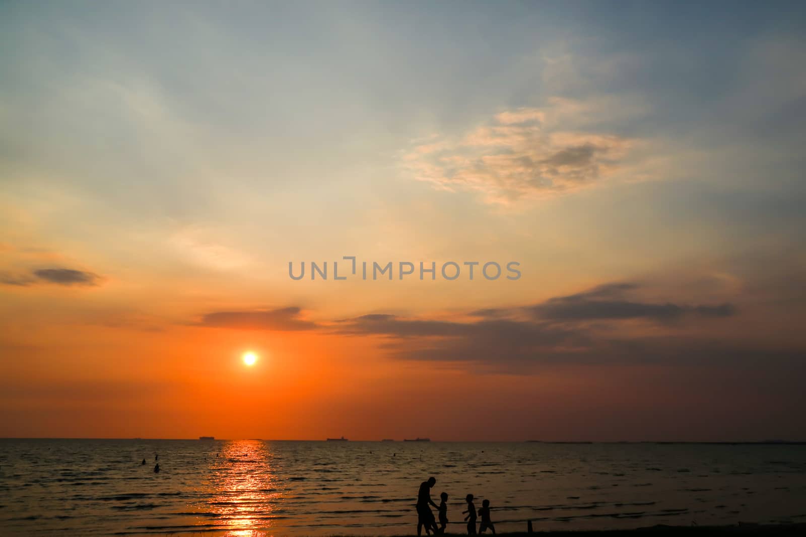 silhouette man and children play on beach and sunset by Darkfox