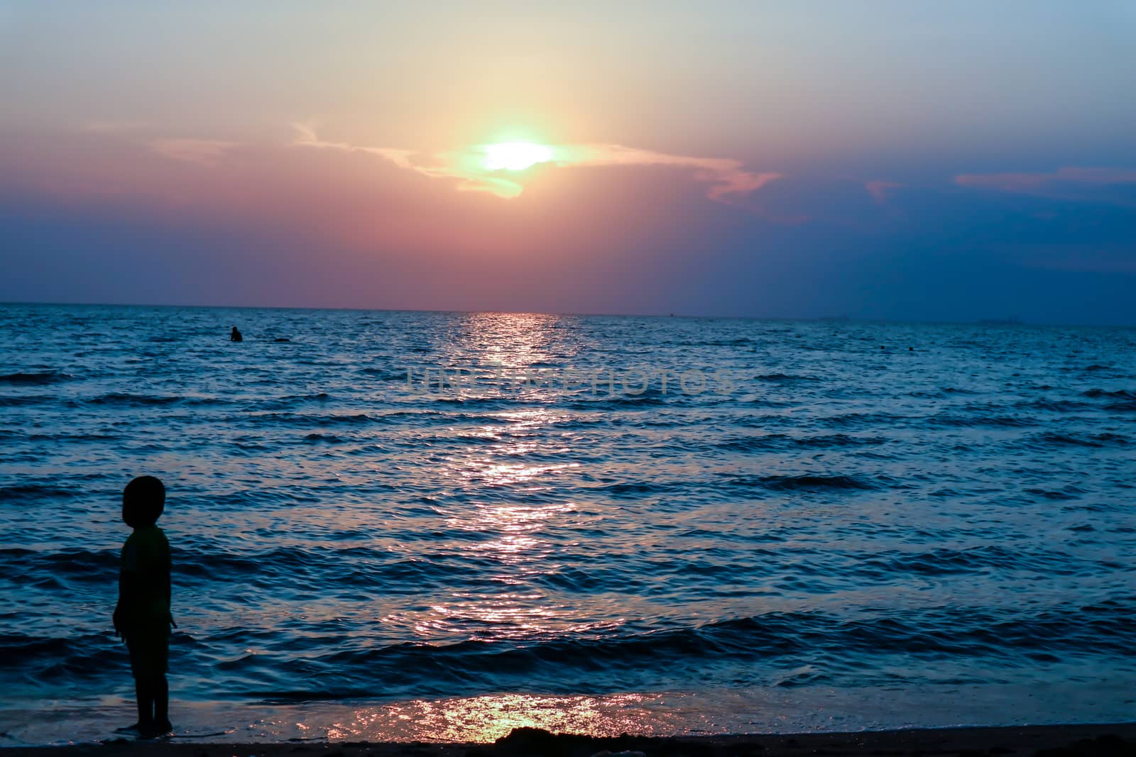 silhouette one kid  standing on sea sunset by Darkfox