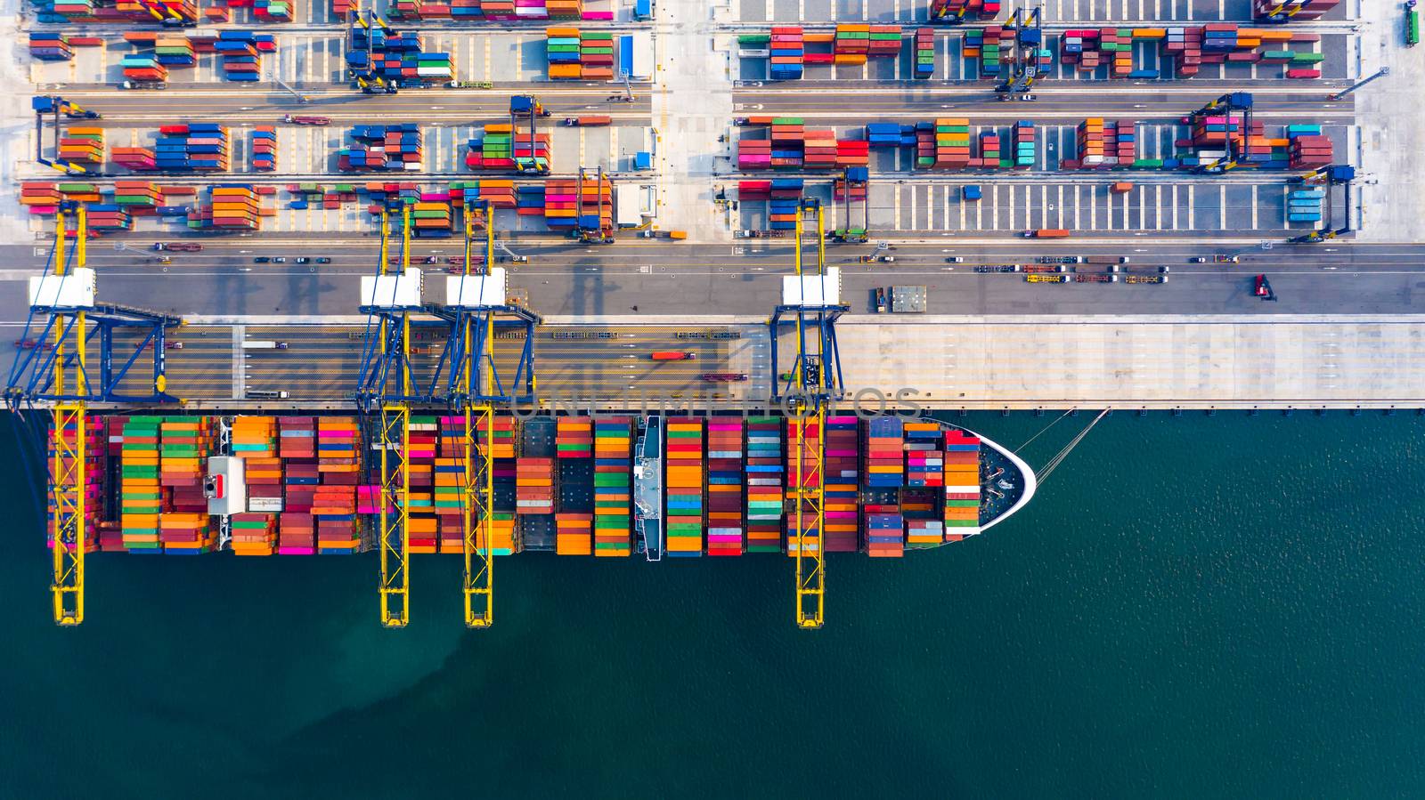 Aerial top view container ship at terminal seaport with tugboat, Global business cargo freight ship import export logistic and transportation by container vessel ship company worldwide.