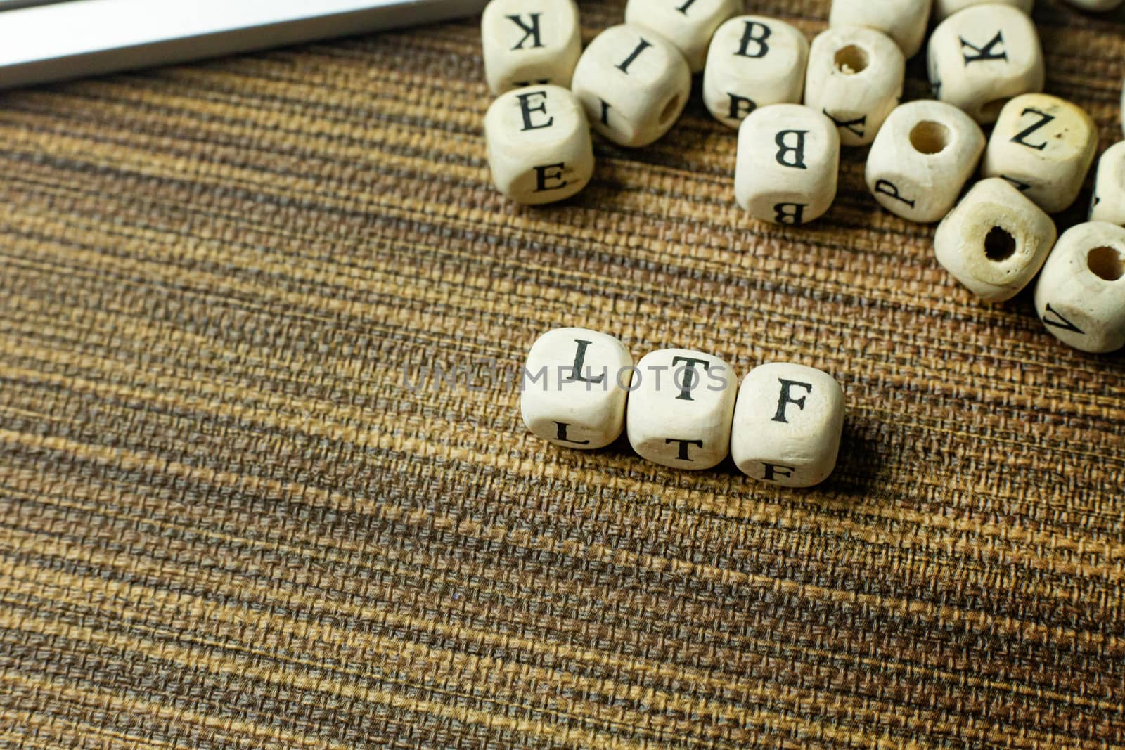 Text LTF on wooden cube  for business content.