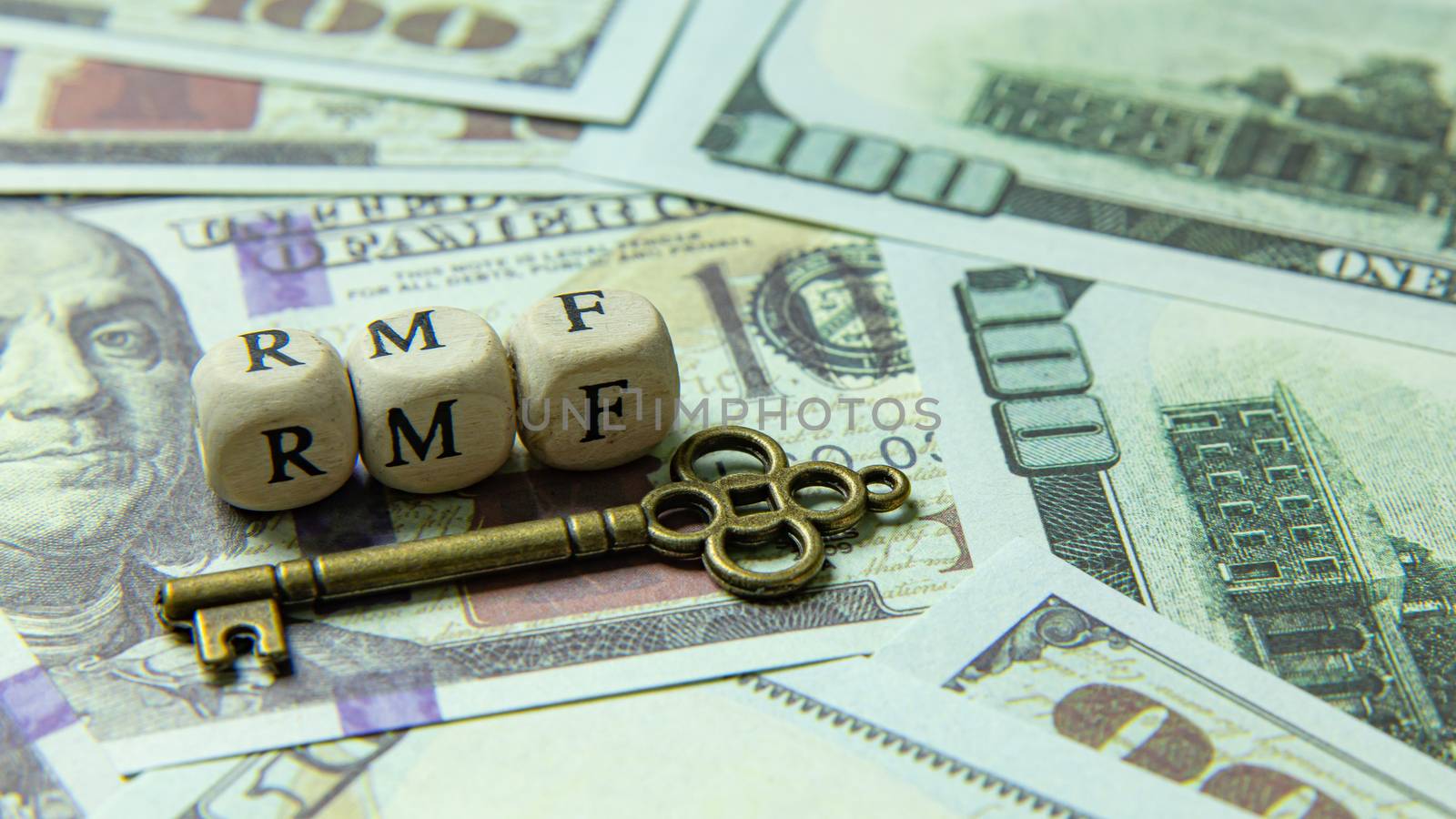 The rmf wooden cube  and gold keyon banknotes for business content.