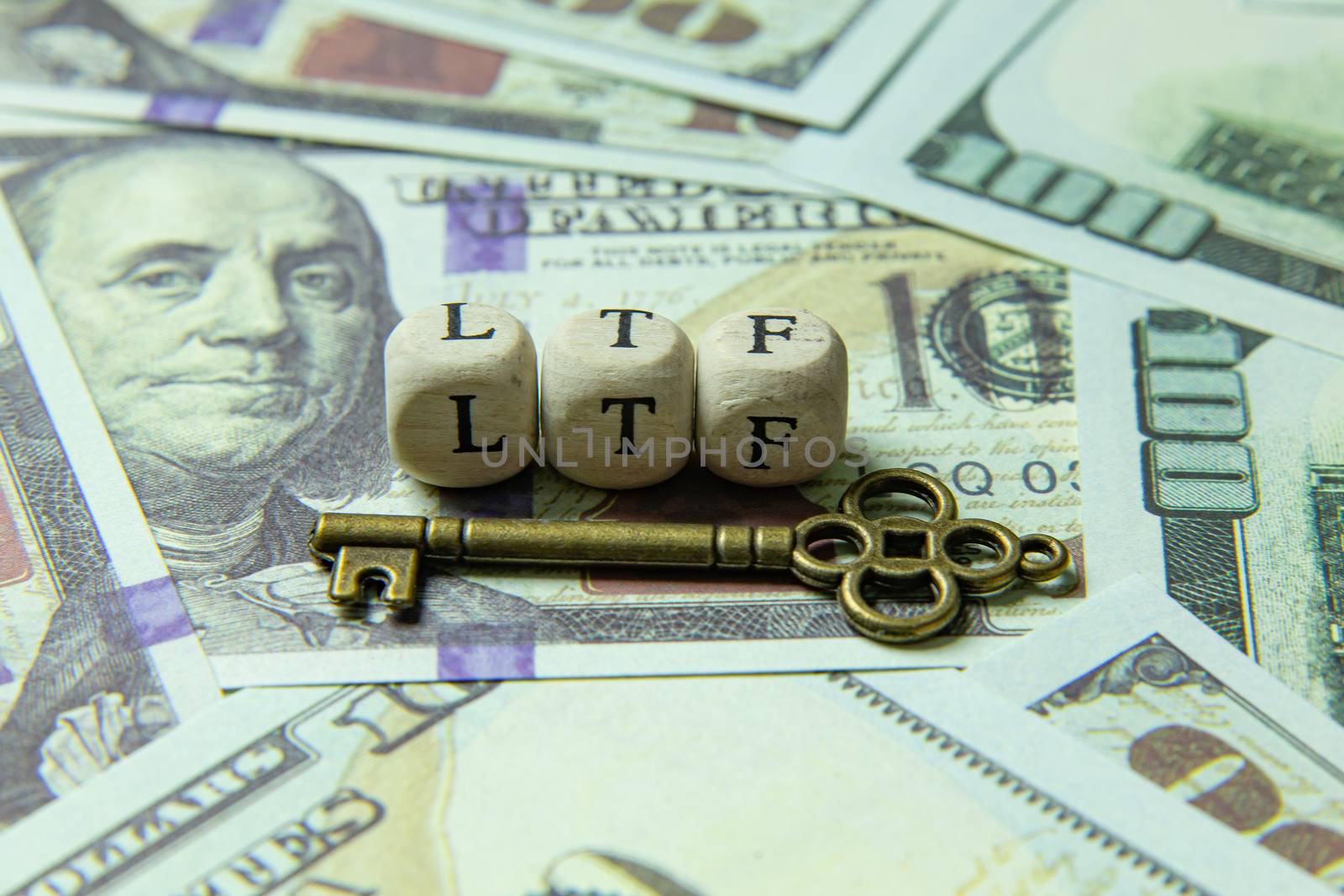 The ltf  wooden cube and gold key on banknotes for business content.