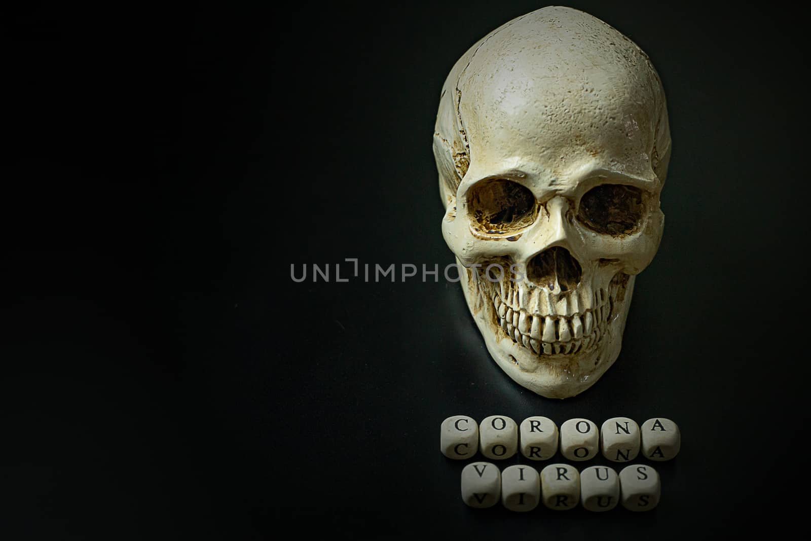 The corona virus  wooden cube and skull  on black background for medical content.