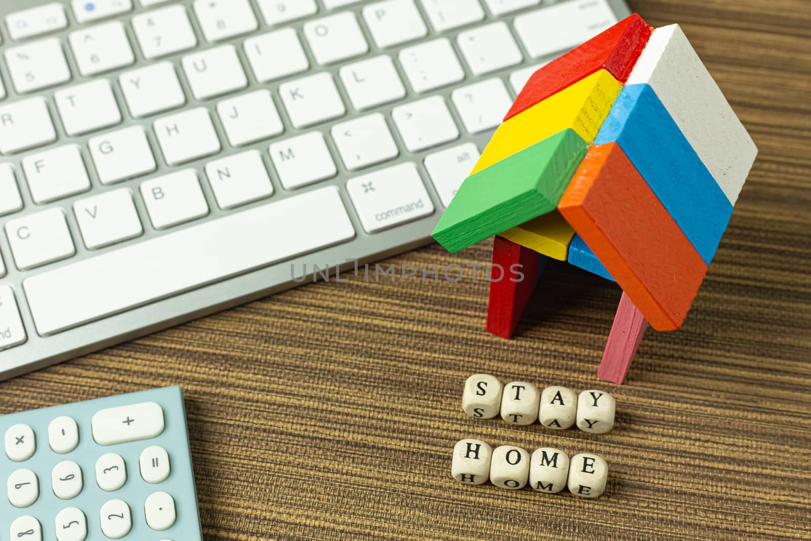 The stay home on wood cube and home toy for social distancing content.