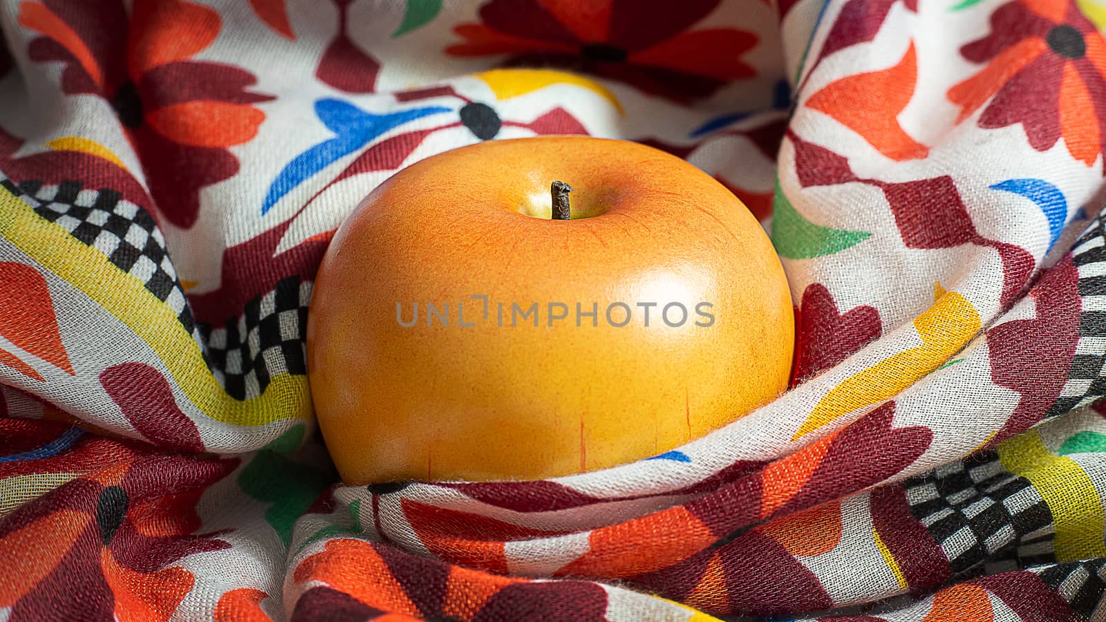 A apple on scarf low light for food content.