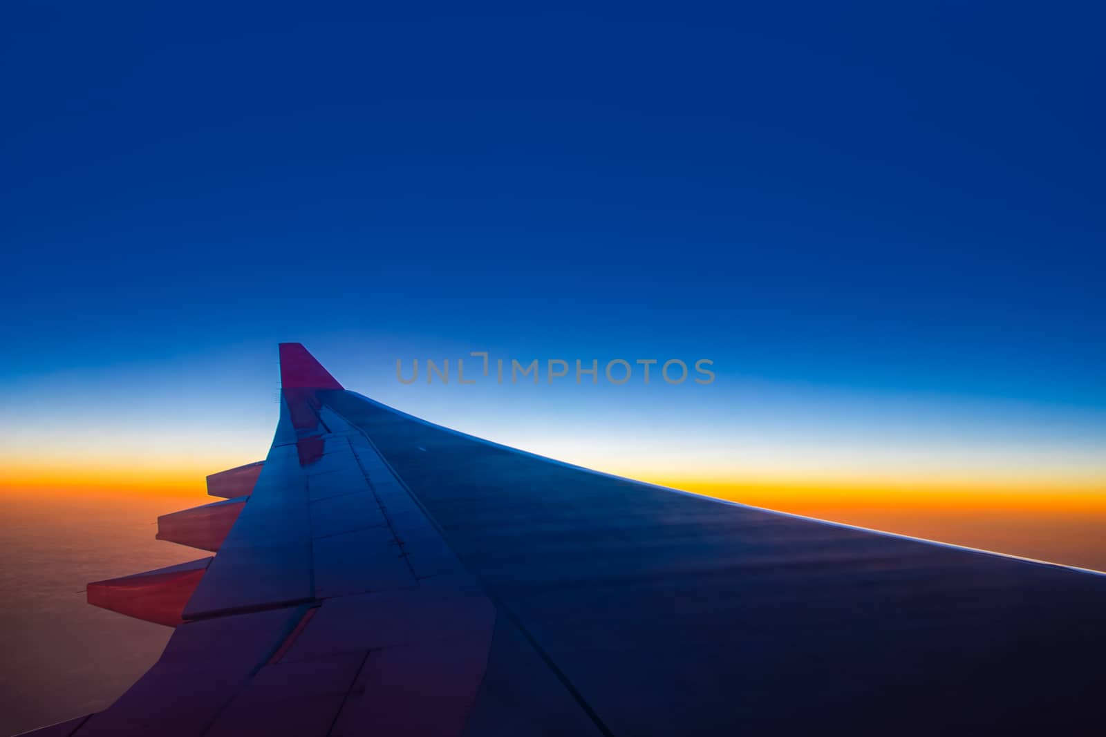 Sunset sky from the airplane window at height 35,000 feet.