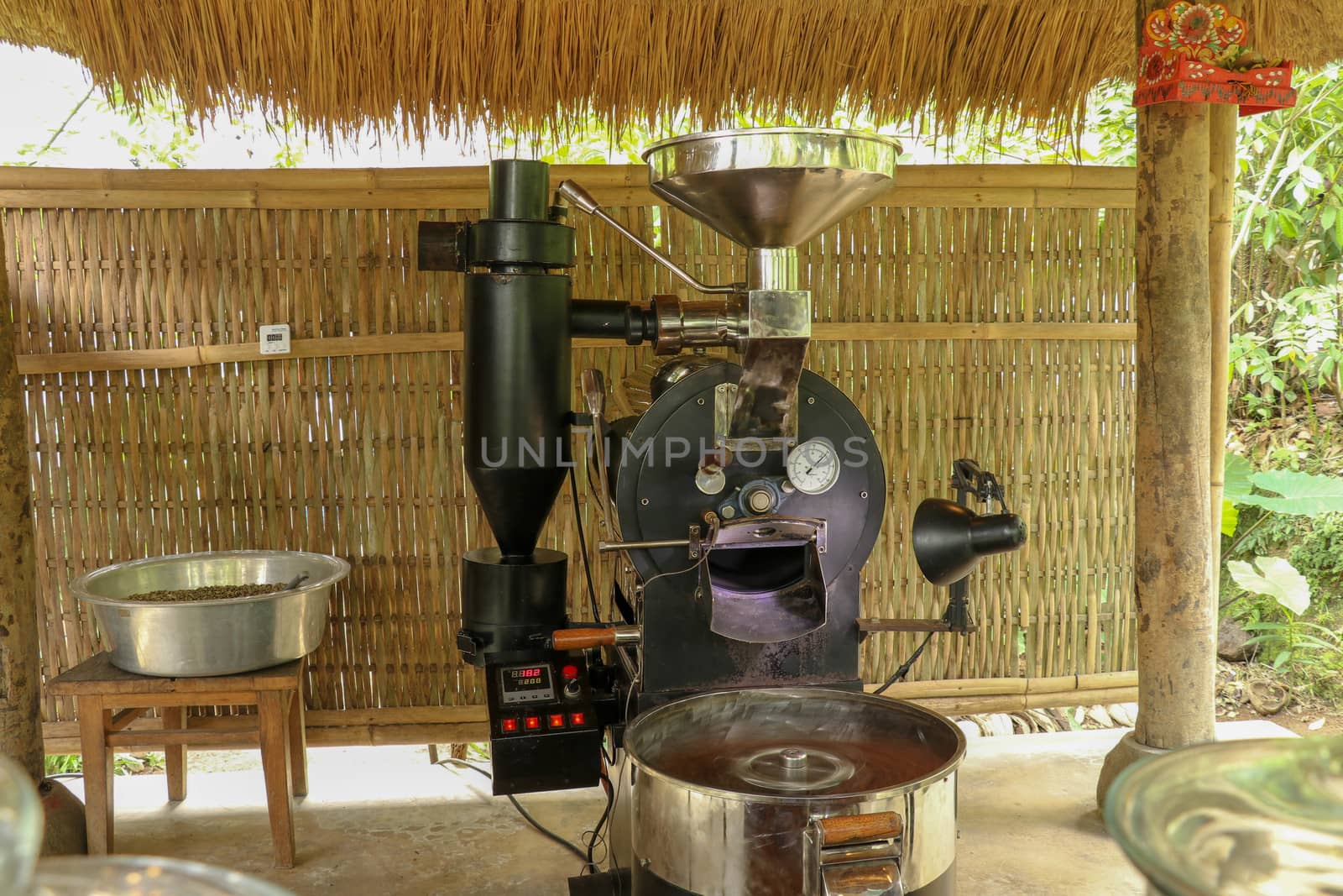 Coffee roasting machine. Professional roasting machine on coffee factory. New modern roasting equipment on coffee farm in Bali, Indonesia. Production of coffee Arabica dan Kopi Luwak.