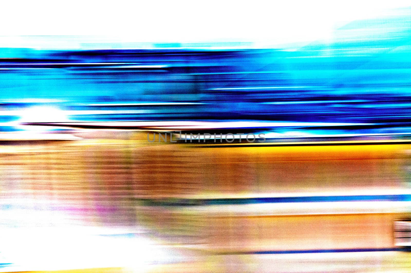 A blue and orange abstract photographic view of buildings in movement in the city, with a grain reticulation texture effect