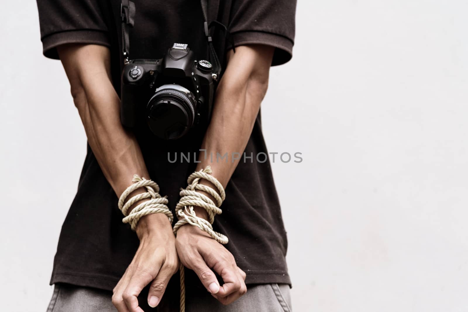 slave photographer / photographer has bundle by rope