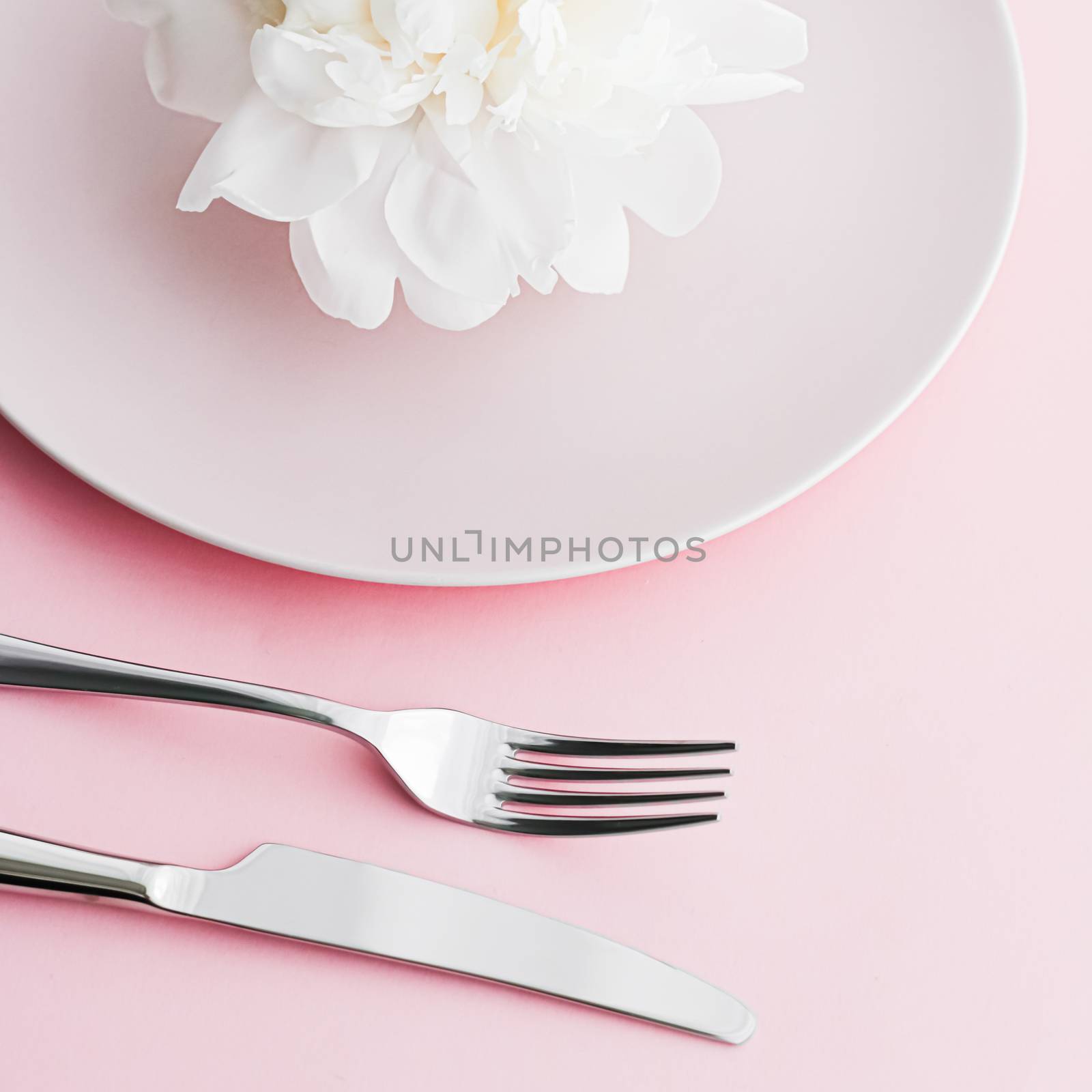 Dining plate and cutlery with peony flower as wedding decor set on pink background, top tableware for event decoration and dessert menu by Anneleven