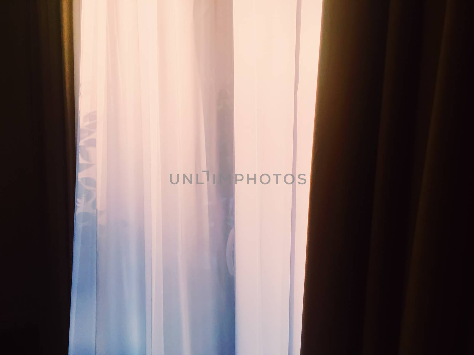 Curtains on window at sunset, furniture and design