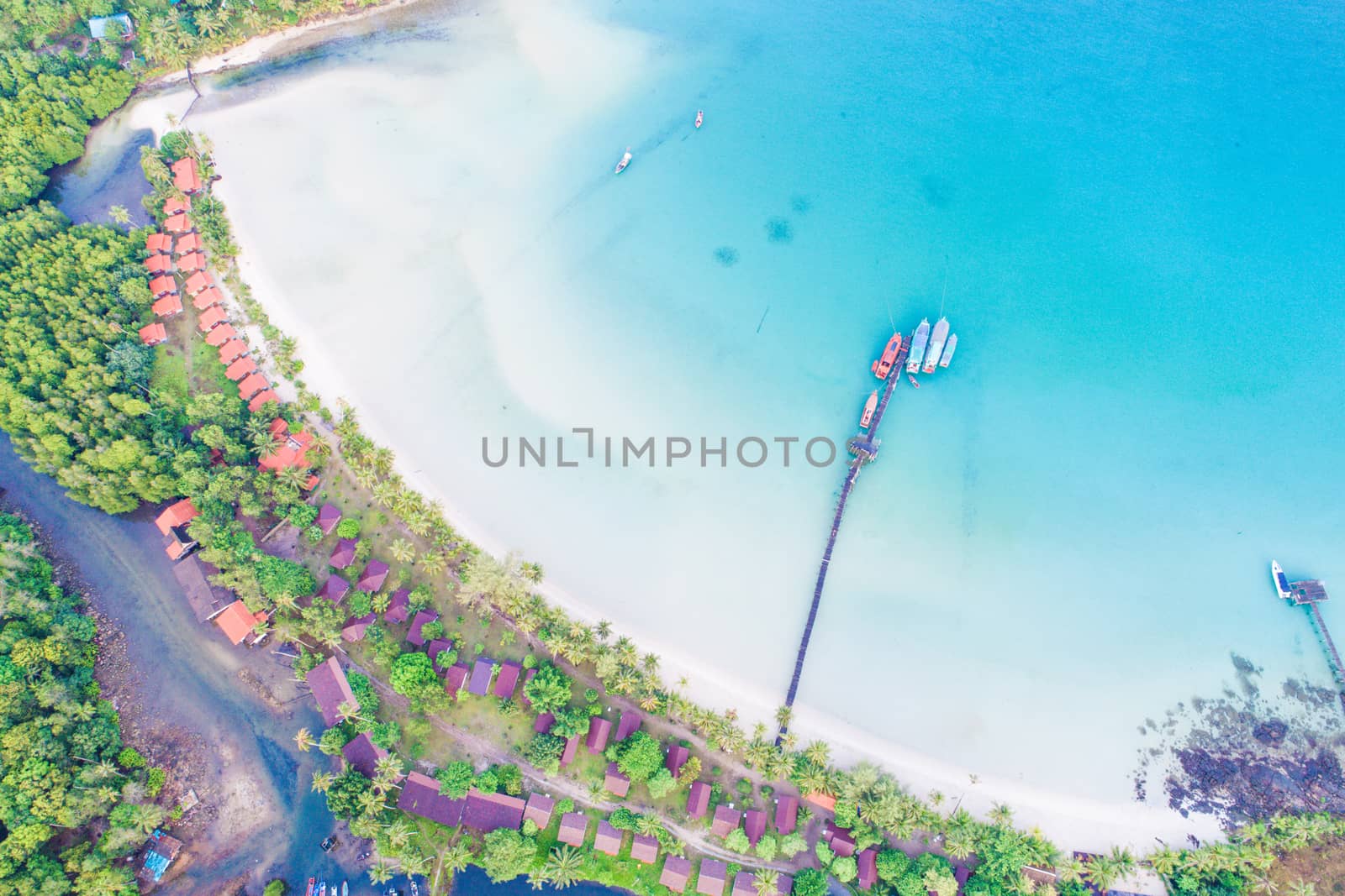 Aerial sea view of beautiful curve beach with wooden pier by themorningglory