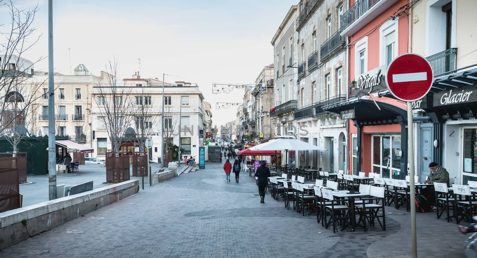 People walking in a shopping street in the historic city center  by AtlanticEUROSTOXX