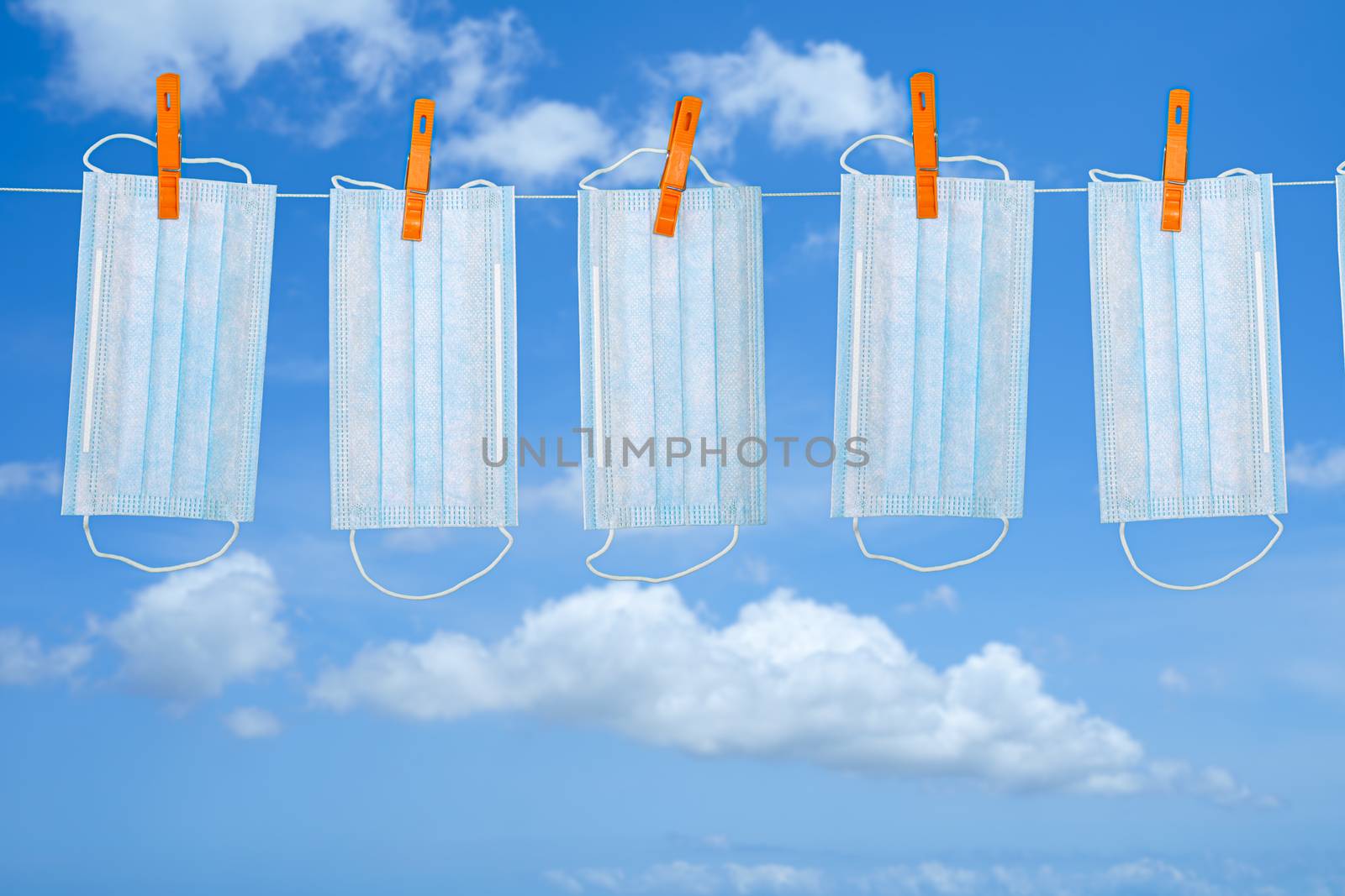 Drying mask hanging under the sun after use for disinfecting. Copy space available.