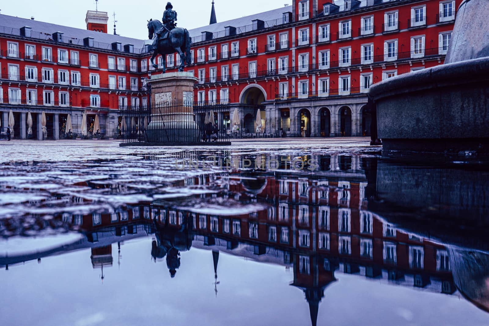 Plaza Mayor of Madrid after the storm, reflected on the ground.