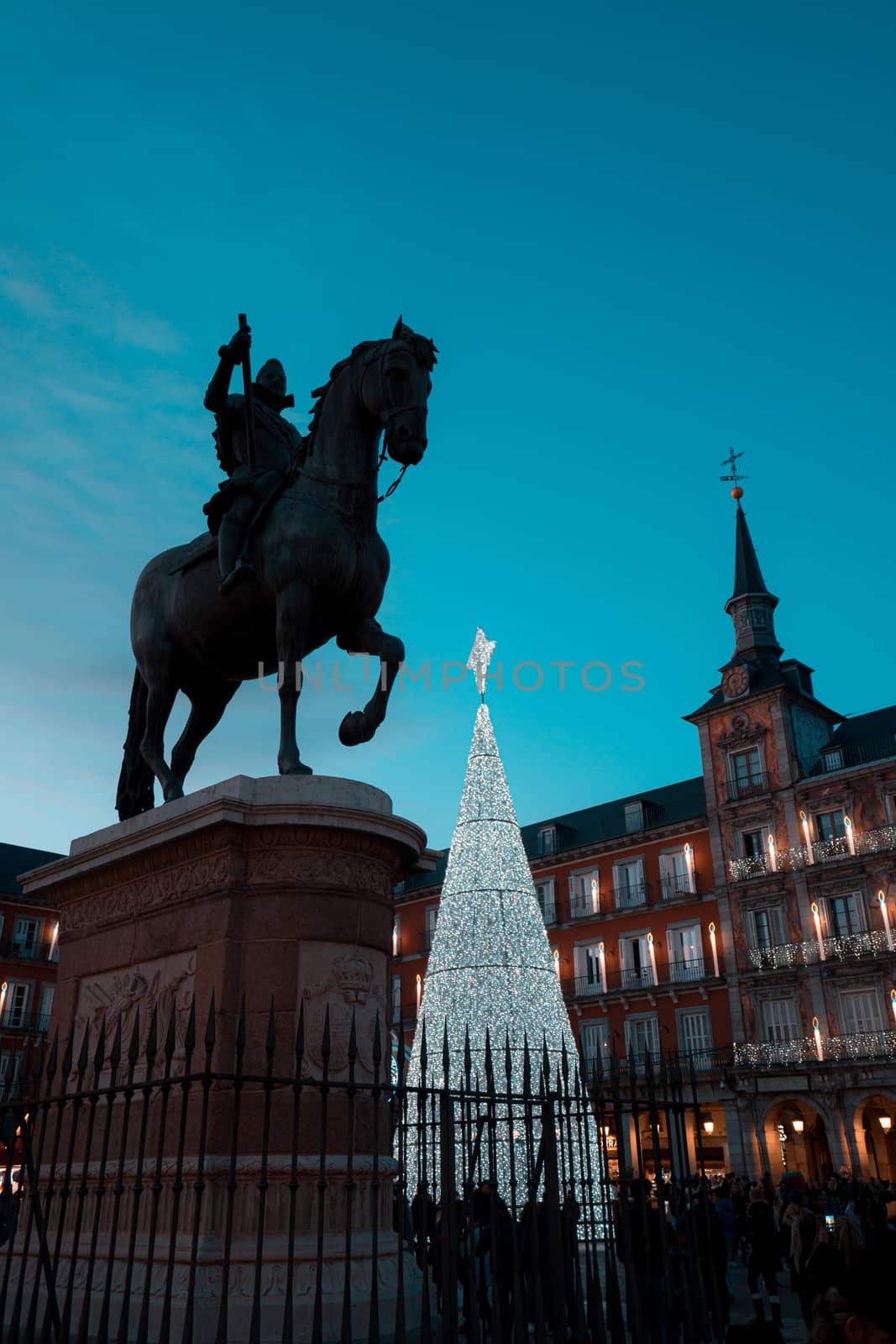 Madrid, bronze statue of King Philip III and illuminated christmas tree in Plaza Mayor by tanaonte