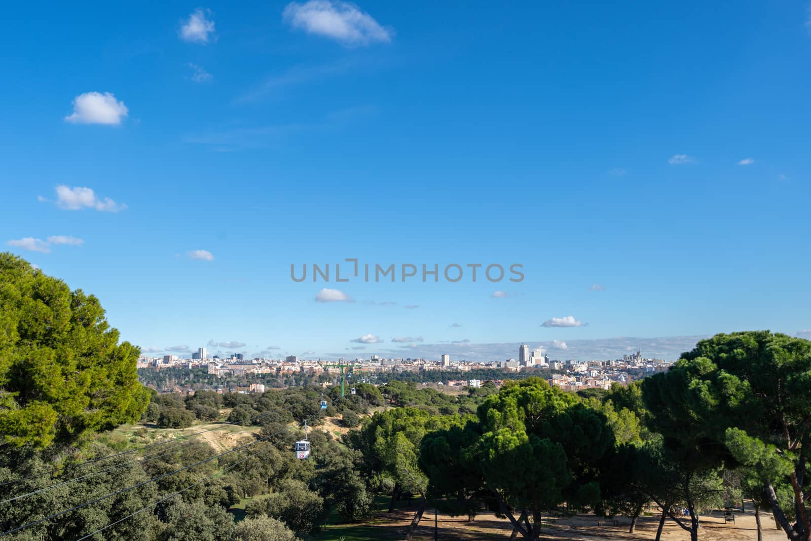 Cable car over casa de campo park in Madrid, Spain. by tanaonte