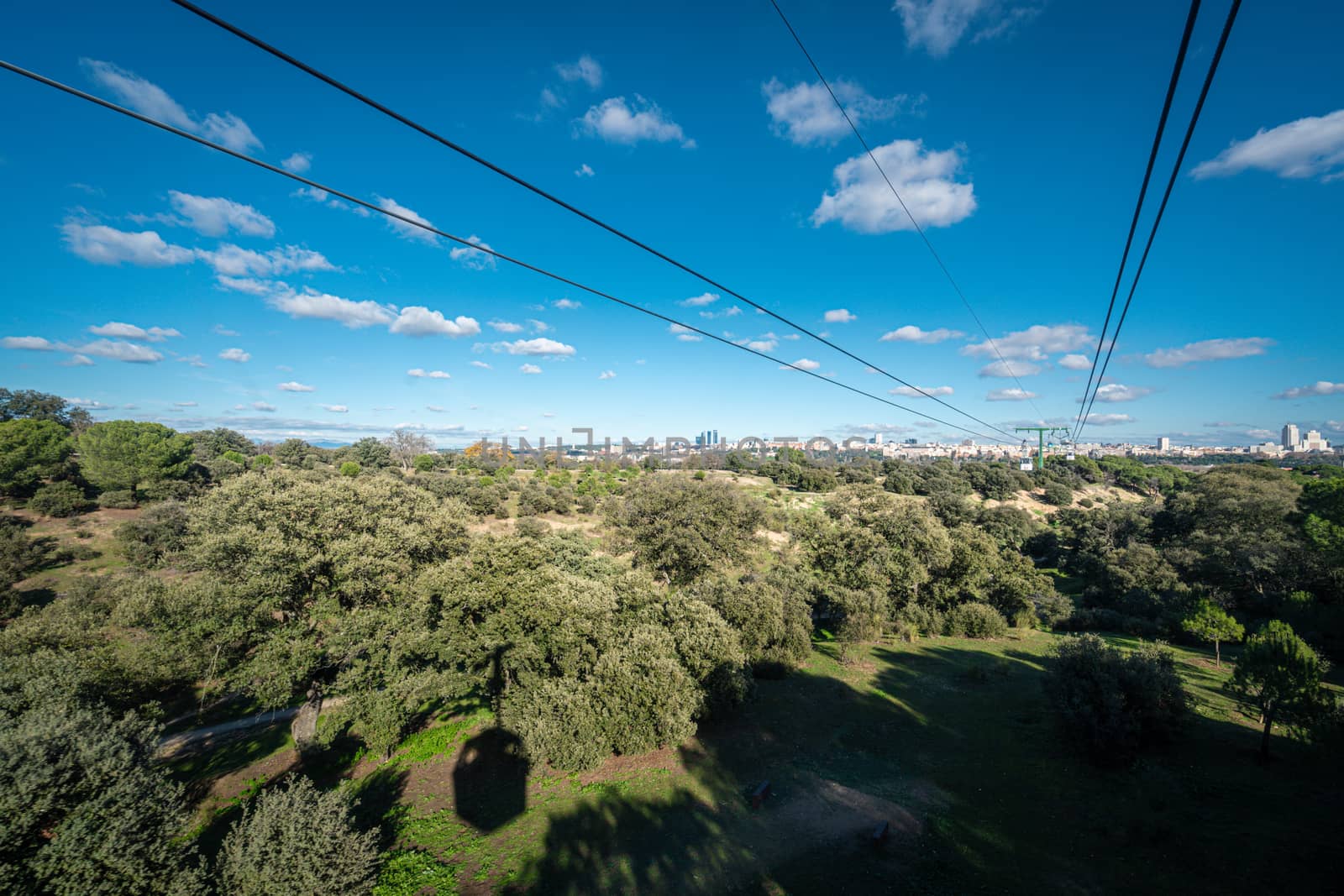 Cable car over casa de campo park in Madrid, Spain. by tanaonte