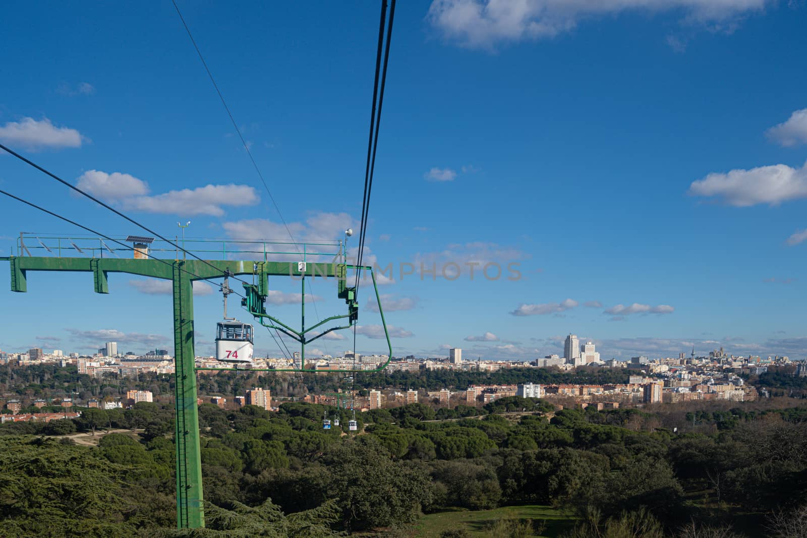 Cable car over casa de campo park in Madrid, Spain. by tanaonte
