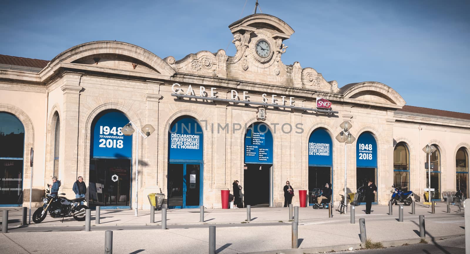 Sete, France - January 4, 2019: People are waiting or walking in front of the SNCF train station under renovation work in the city center on a winter day