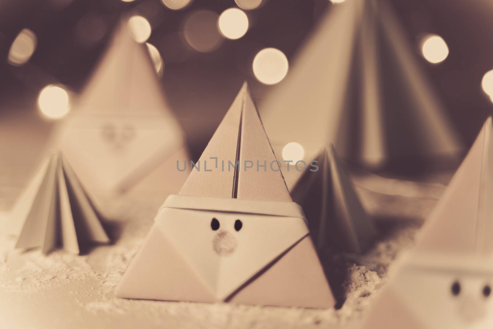 Origami Xmas scene with Santa claus and crhistmas trees in paper craft in sepia tone by tanaonte