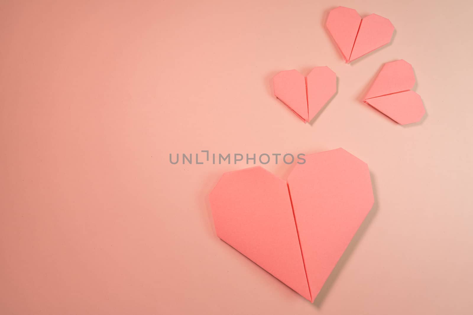 Pink origami hearts on a pink background by tanaonte
