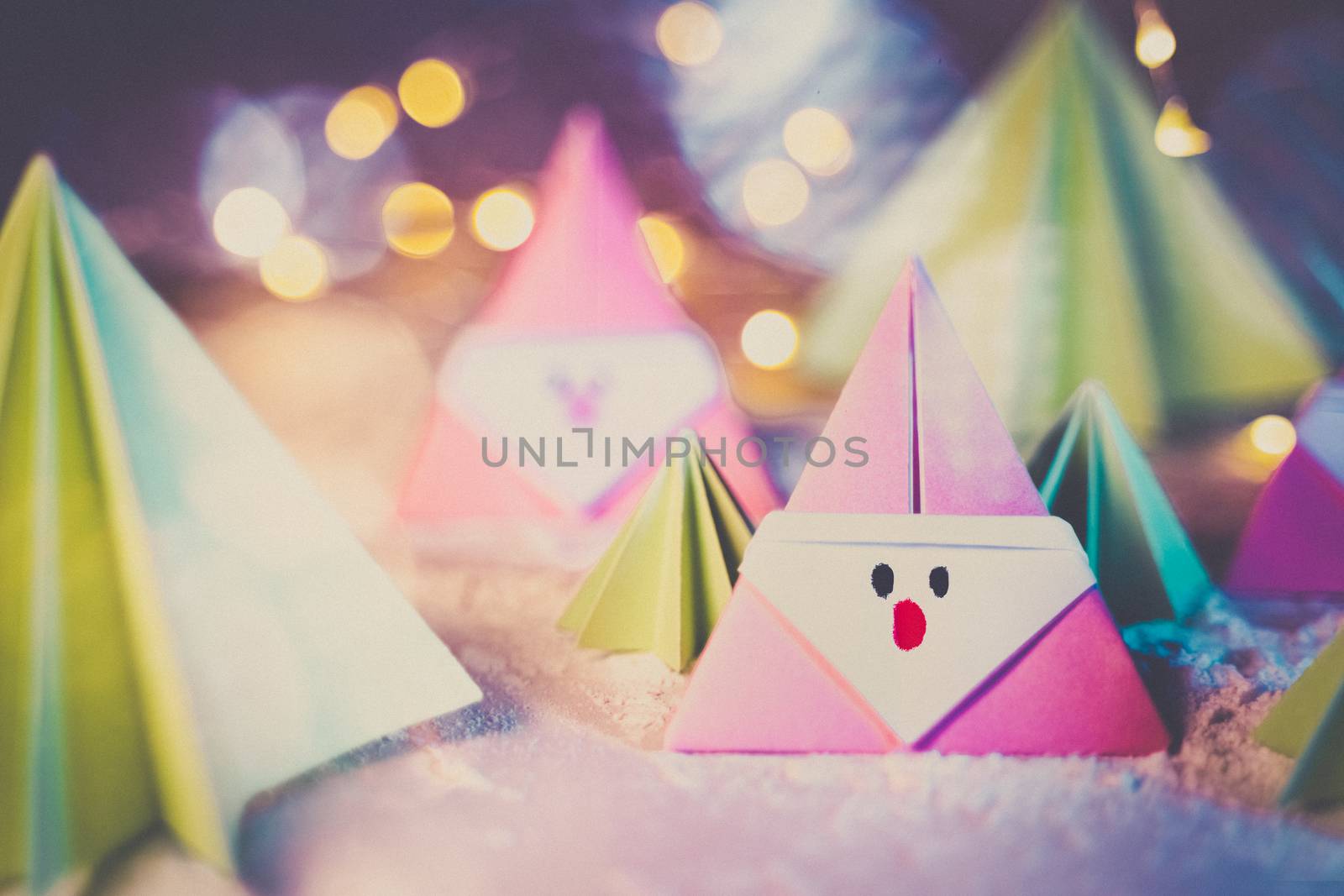 Origami Xmas scene with a pink Santa claus and crhistmas trees in paper craft