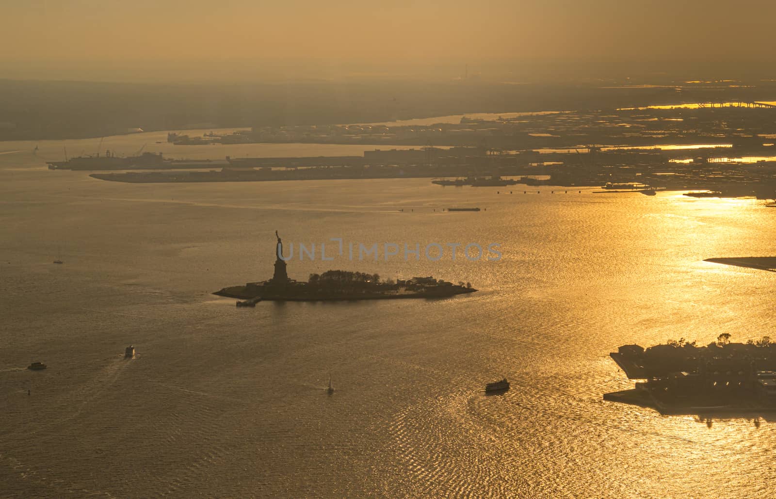 Liberty island and Statue of Liberty aerial photo at sunset or golden hour