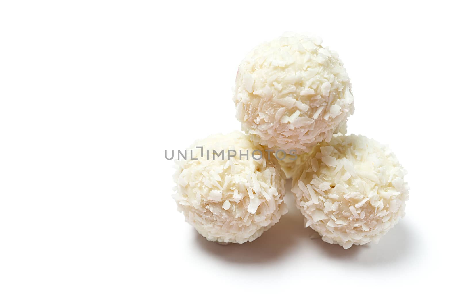 Homemade White Candy With Coconut Topping On White Background. copy space. by PhotoTime