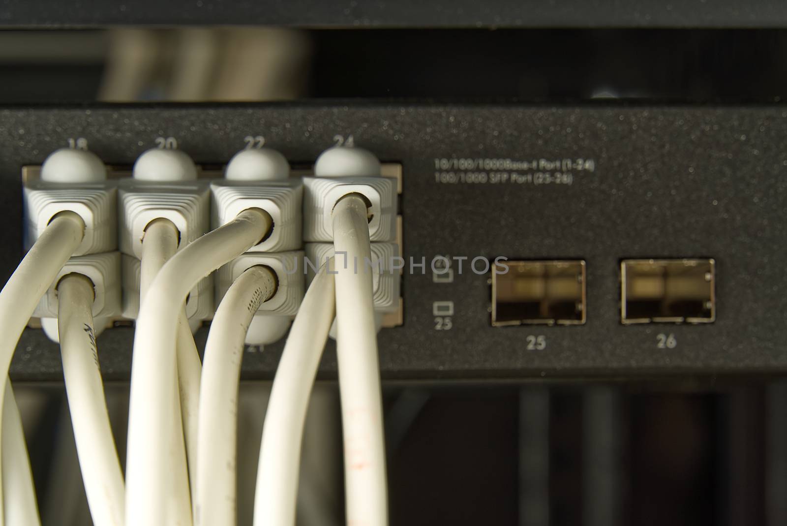 Network switch and ethernet cable in rack cabinet. Network connection technology thrue cat6 and cat5 wires. Network switch and cables
