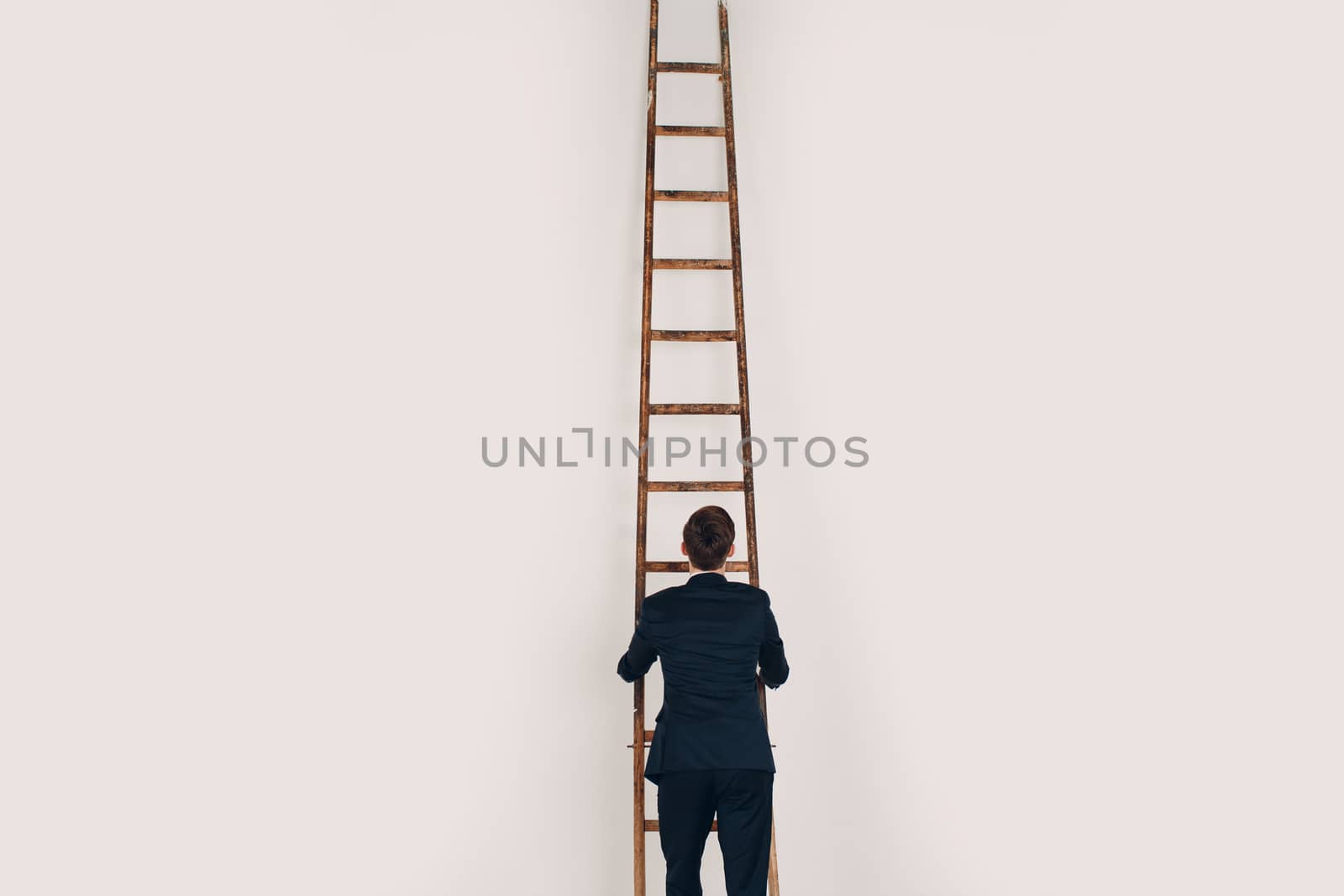 Businessman in black suit lift up the stair. Career and growth in business concept. White background and copy space. by primipil