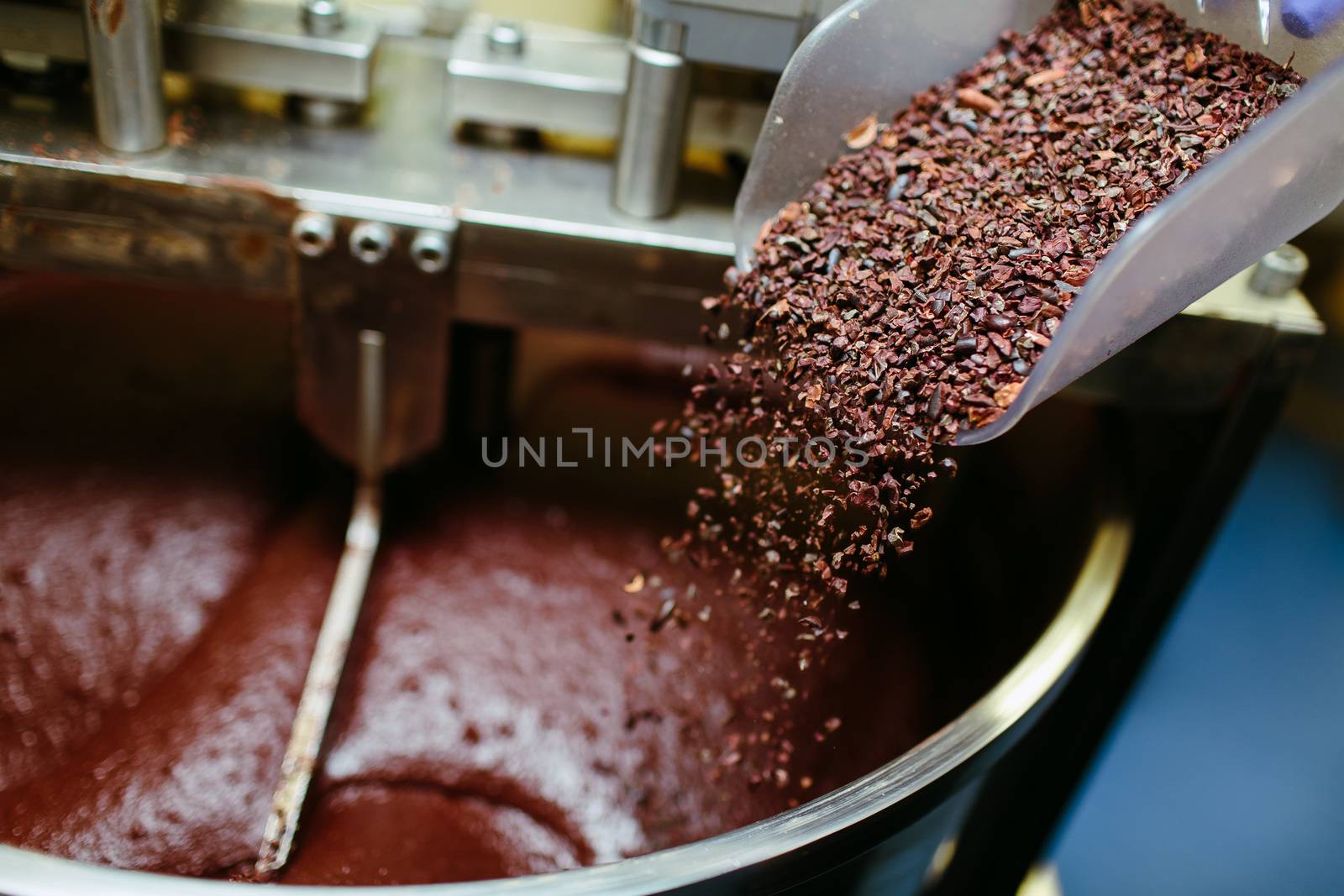 Artisan chocolate making, adding cocoa grits in the Melanger Stone Grinder