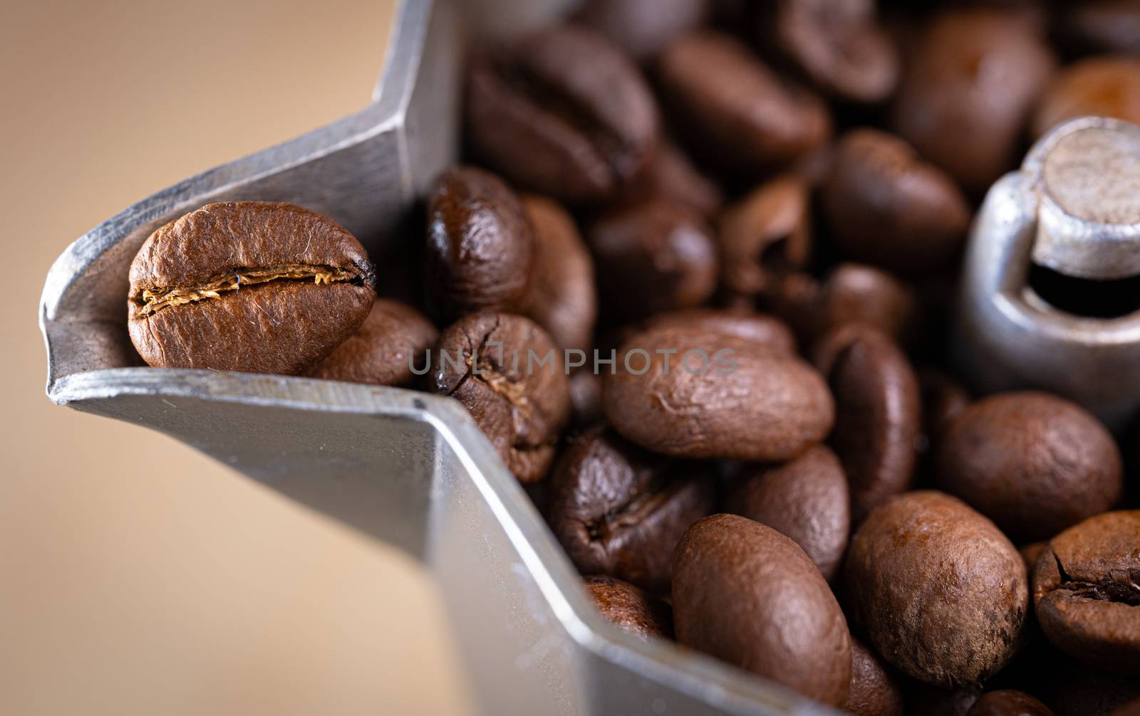 Coffee beans in an italian espresso coffee pot. Morning coffee and relaxing time. Macro shot.