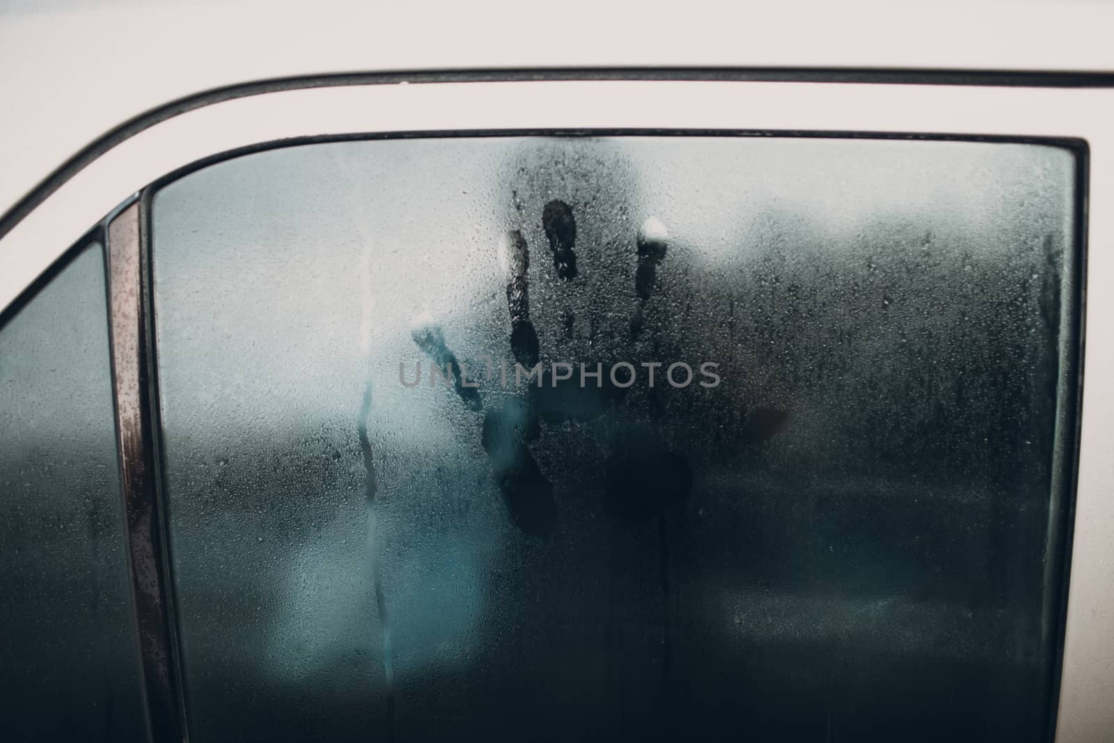 Rain and handprint on glass of car by primipil