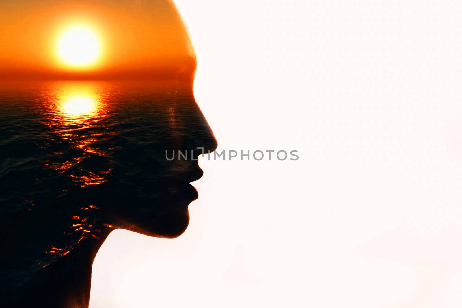 Woman head silhouette with sun inside with copy space. Multiple exposure image.