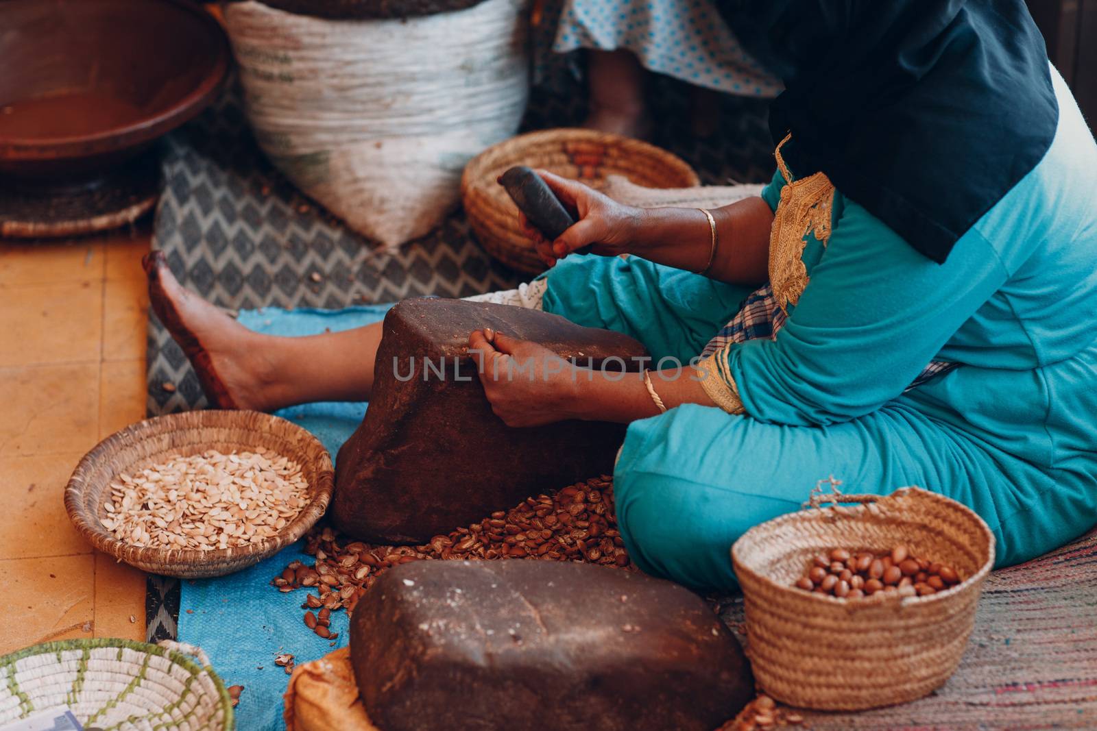 Woman making argan oil by hand craft by primipil