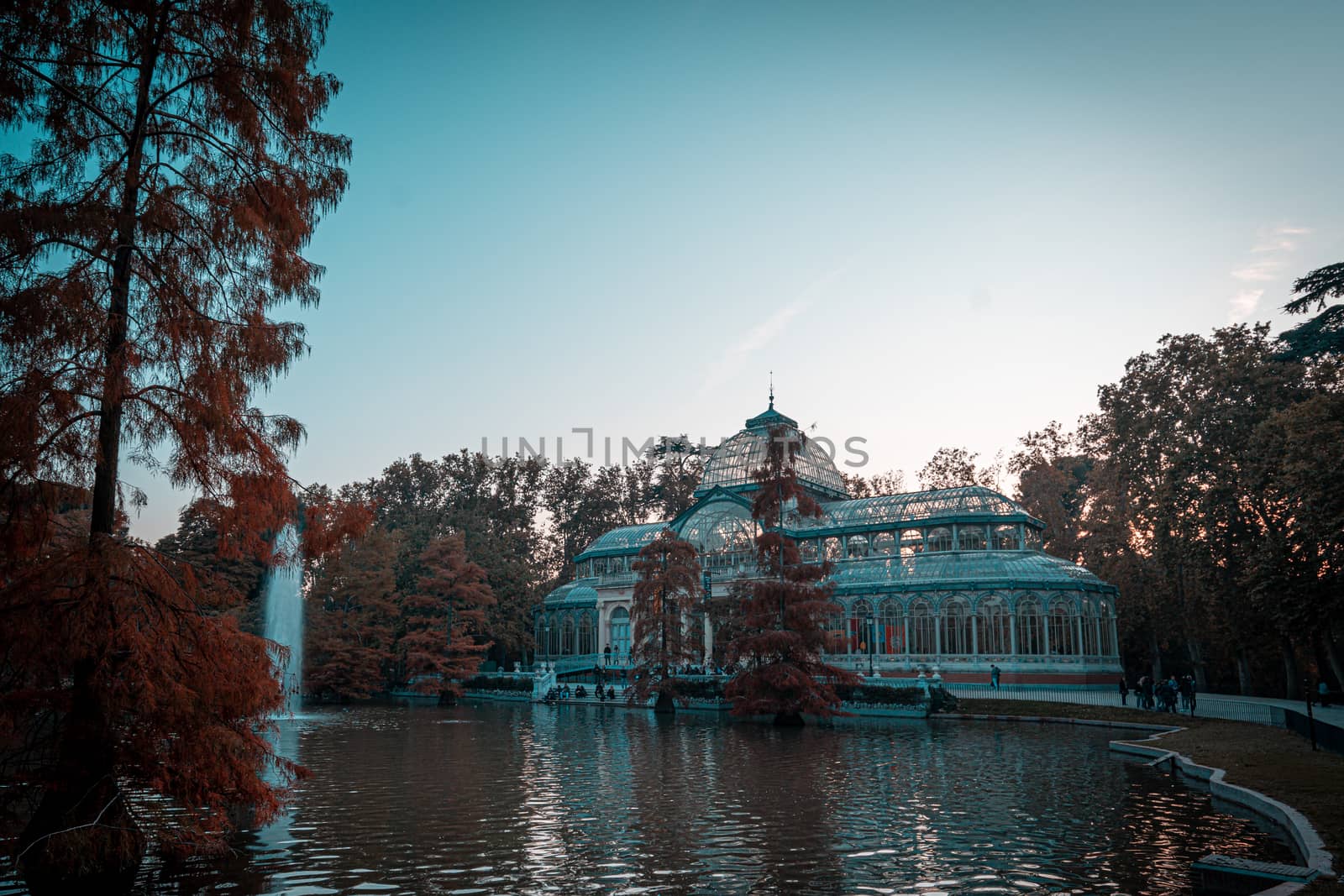 Sunset view of Crystal Palace or Palacio de cristal in Retiro Park in Madrid, Spain. by tanaonte