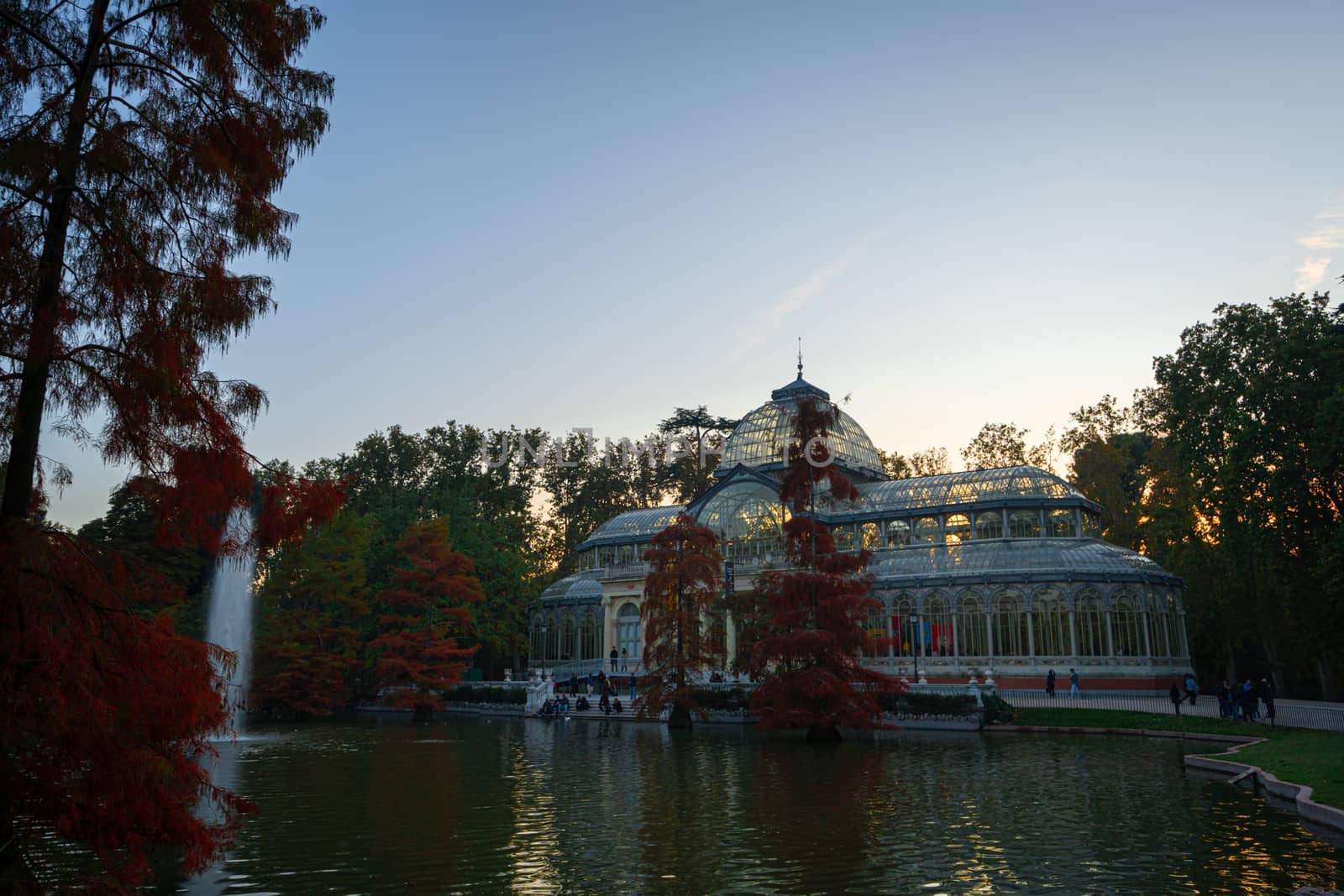 Sunset view of Crystal Palace or Palacio de cristal in Retiro Park in Madrid, Spain. The Buen Retiro Park is one of the largest parks of the city of Madrid, Spain