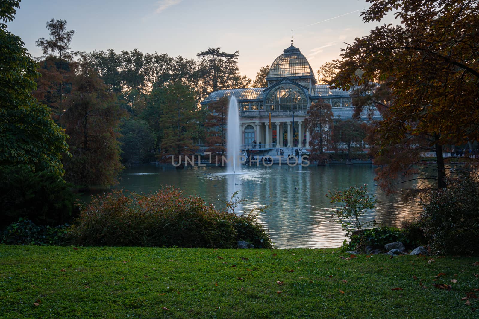 Sunset view of Crystal Palace or Palacio de cristal in Retiro Park in Madrid, Spain. The Buen Retiro Park is one of the largest parks of the city of Madrid, Spain