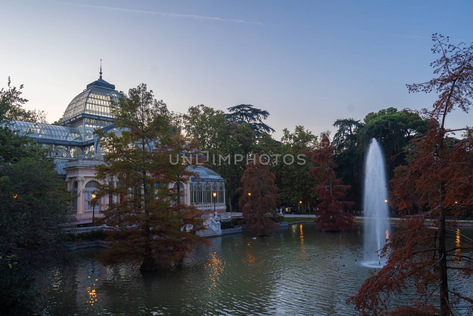 Sunset view of Crystal Palace or Palacio de cristal in Retiro Park in Madrid, Spain. by tanaonte