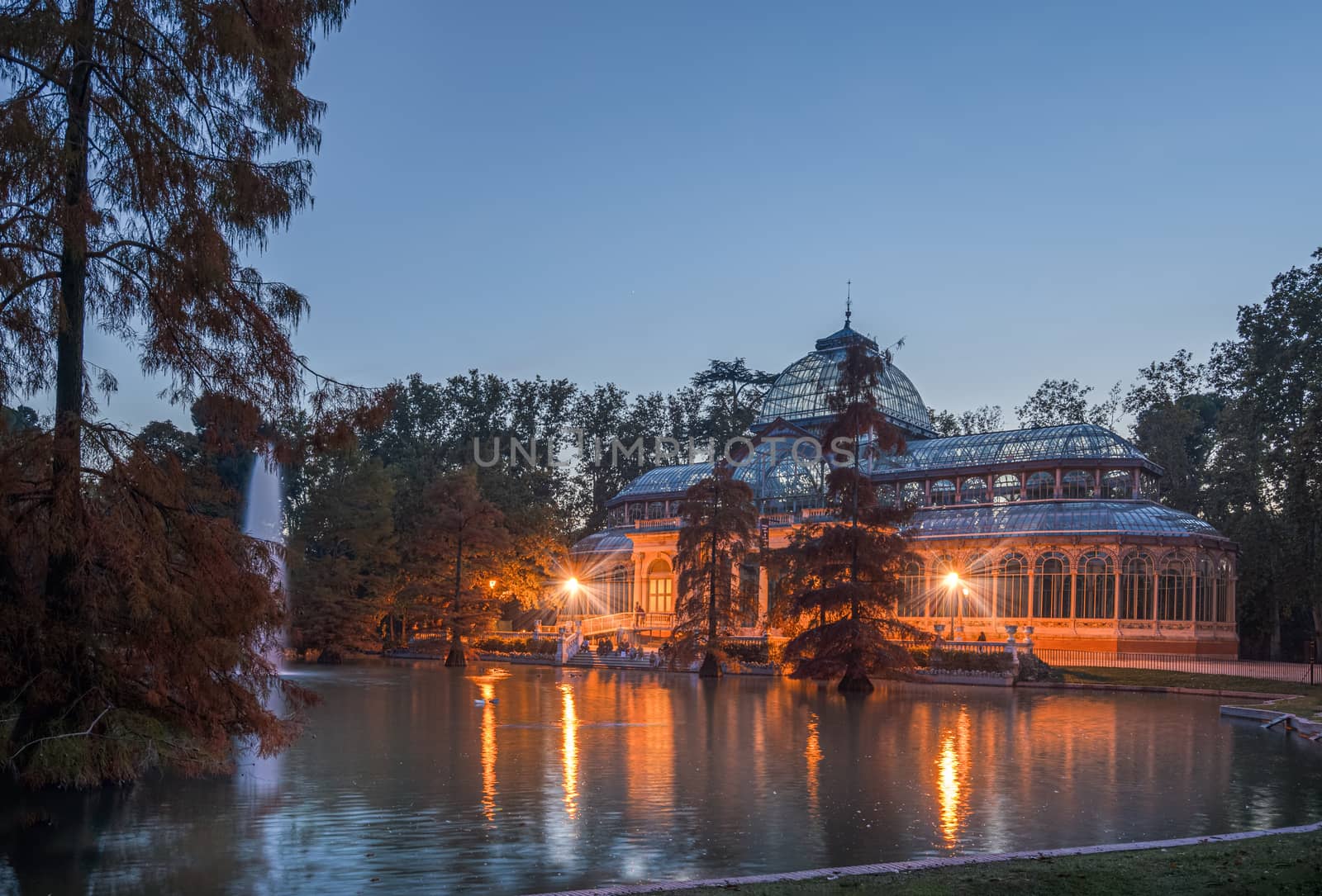 Blue hour view of Crystal Palace or Palacio de cristal in Retiro Park in Madrid, Spain. by tanaonte